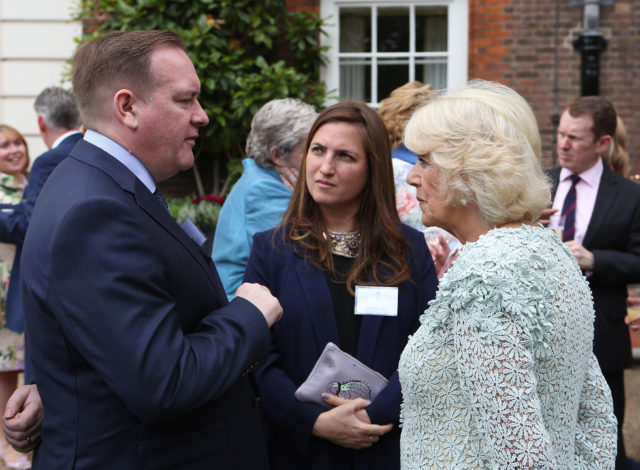 The Duchess of Cornwall speaks to EastEnders producer(formally the Archers) Sean O'Connor (left) and Louiza Patikas who plays Helen in the Archers (centre), during a reception for survivors of domestic abuse