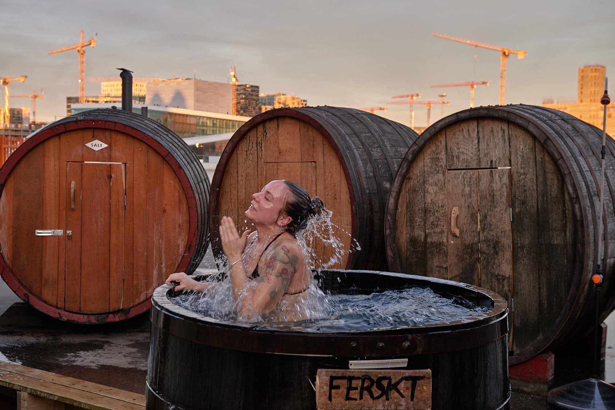 Cooling off in a barrel of cold water outside the sauna at SALT. (Baard Henriksen/PA)
