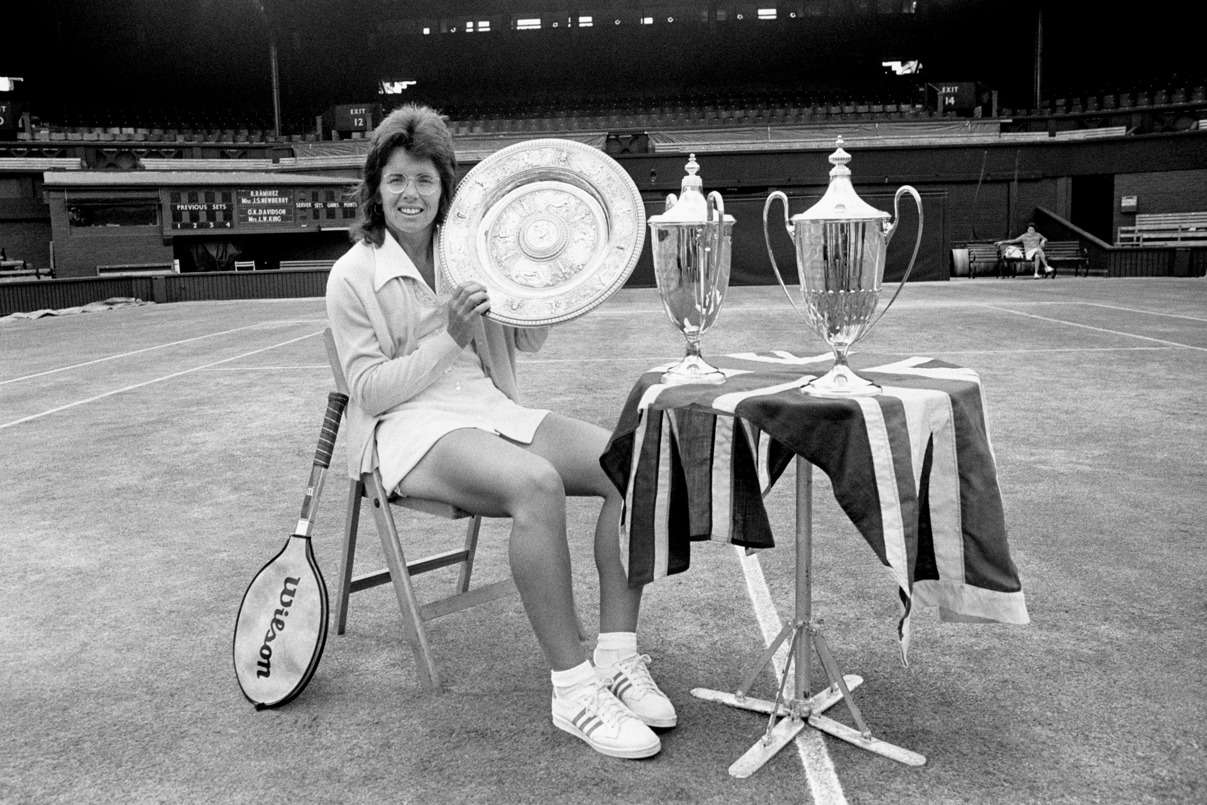 Billie Jean King on Centre Court with her three trophies (PA)