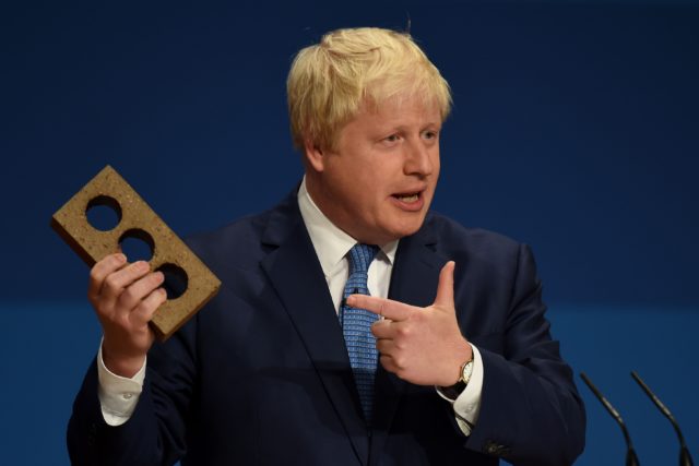 Boris Johnson holding a brick (Joe Giddens/PA)
