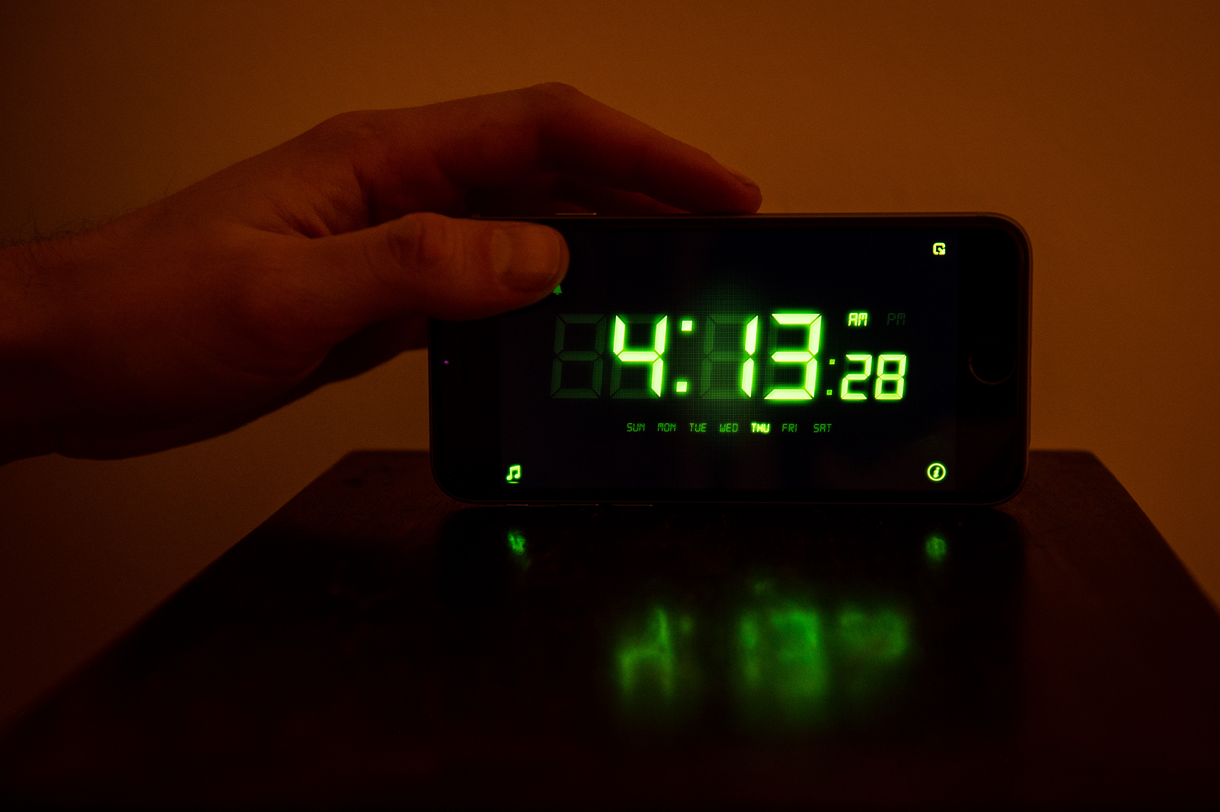 A man touches his clock