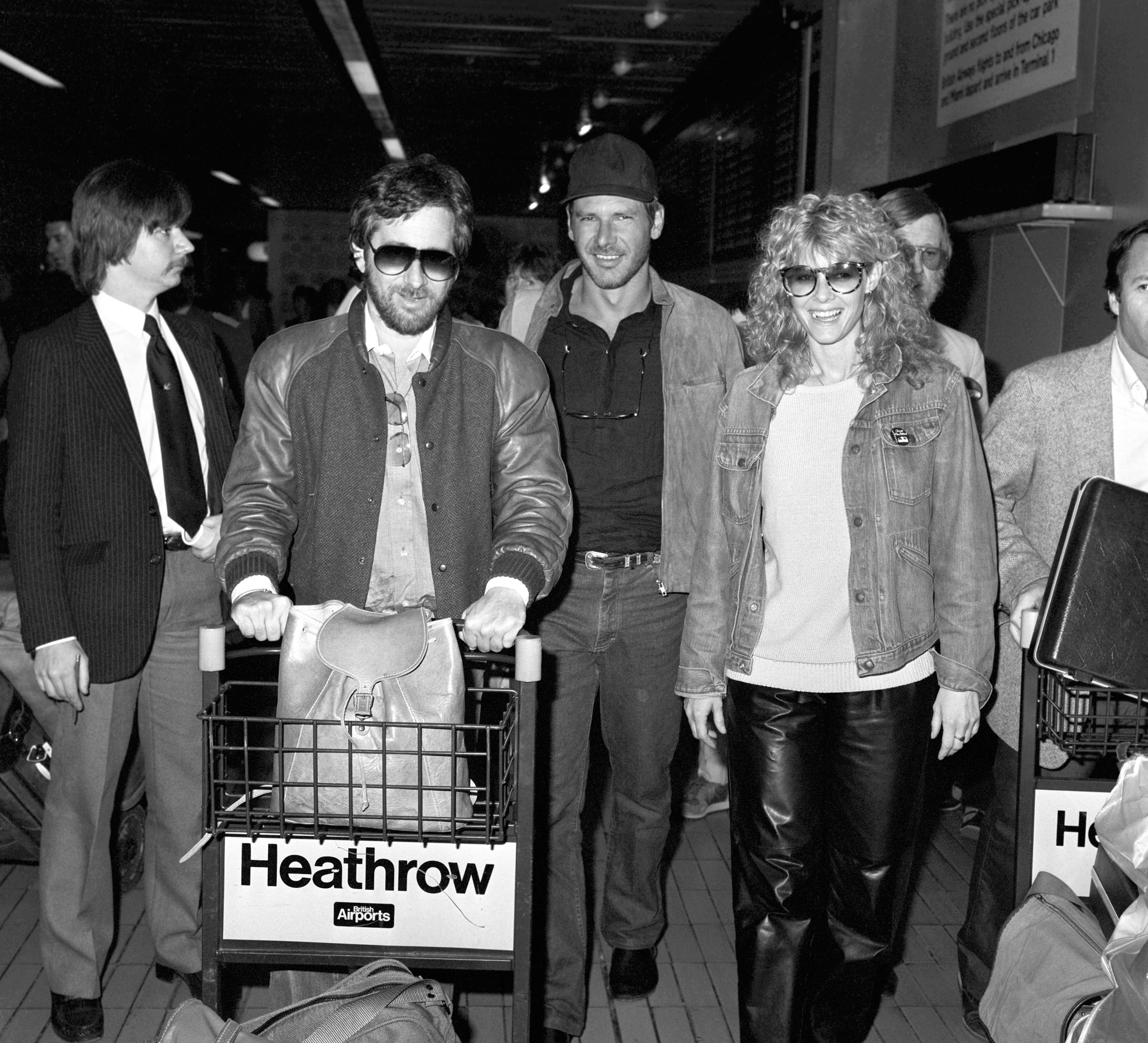 Director Stephen Spielberg (left) arriving at Heathrow airport with Harrison Ford and Kate Capshaw.