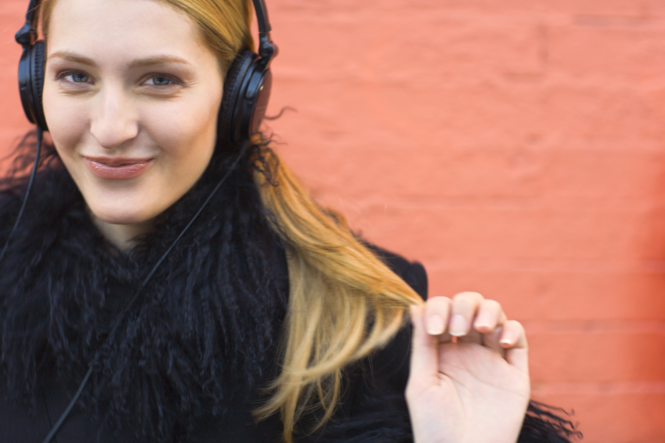 Young woman wearing headphones and listening to a podcast (Thinkstock/PA)