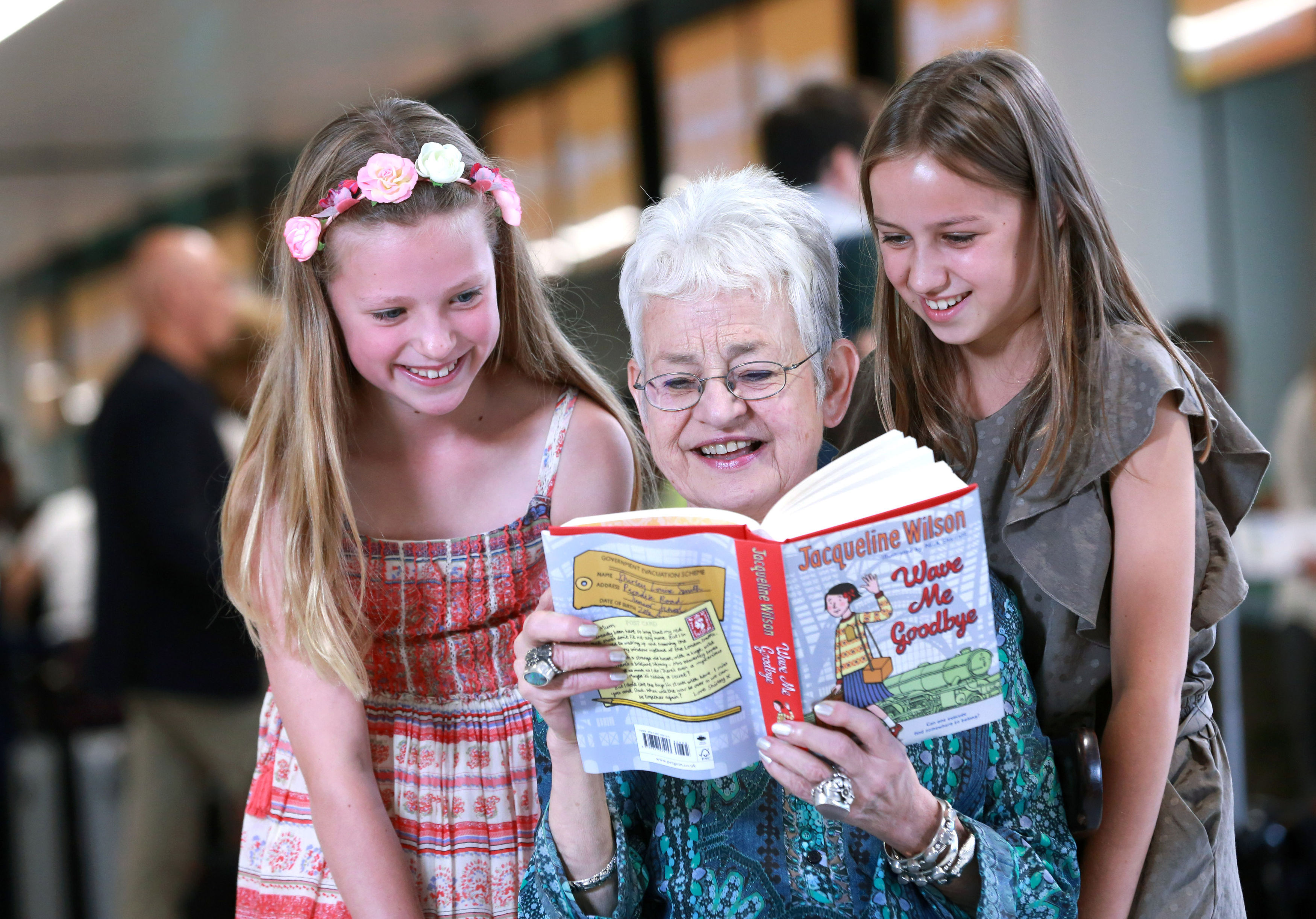 Dame Jacqueline Wilson is joined by Sophie Raison, nine, and Elise Whitley, 10, as she helps to launch the easyJet Book Club (Matt Alexander/PA)