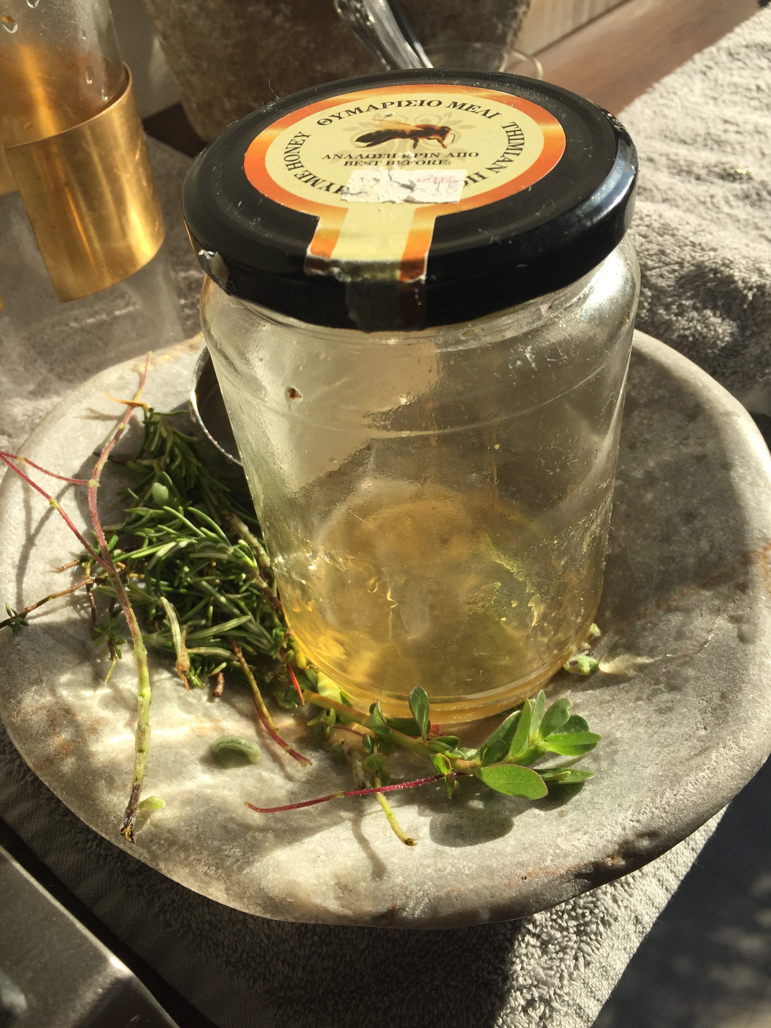 Fresh herbs alongside a jar of honey (PA)