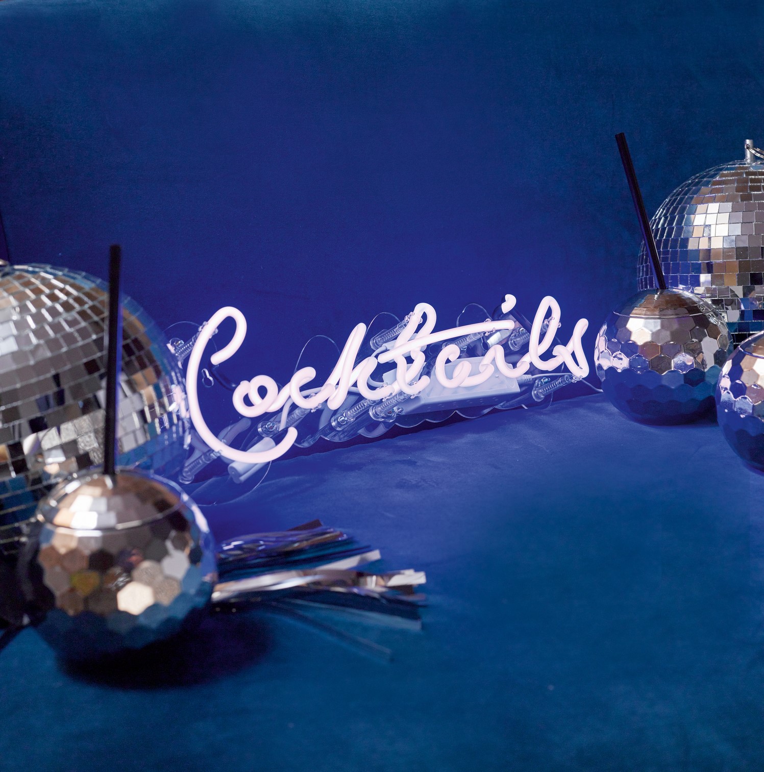 Cocktails neon light, £69.99, Glitterati disco ball, £13.99; and disco ball shaped cups £9.99 for a pack of two, Talking Tables (Talking Tables/PA)