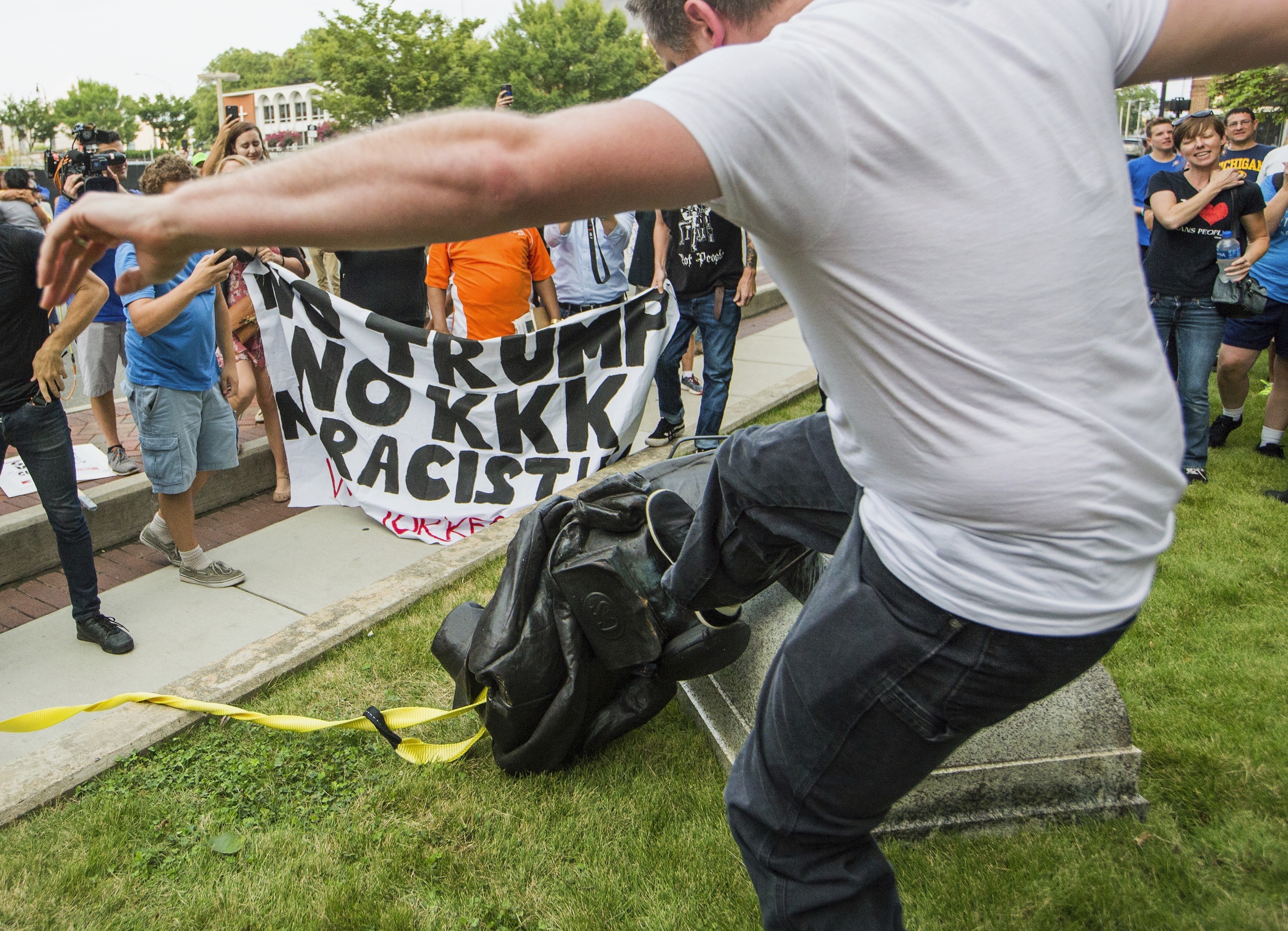 Protesters stamp on the statue in Durham