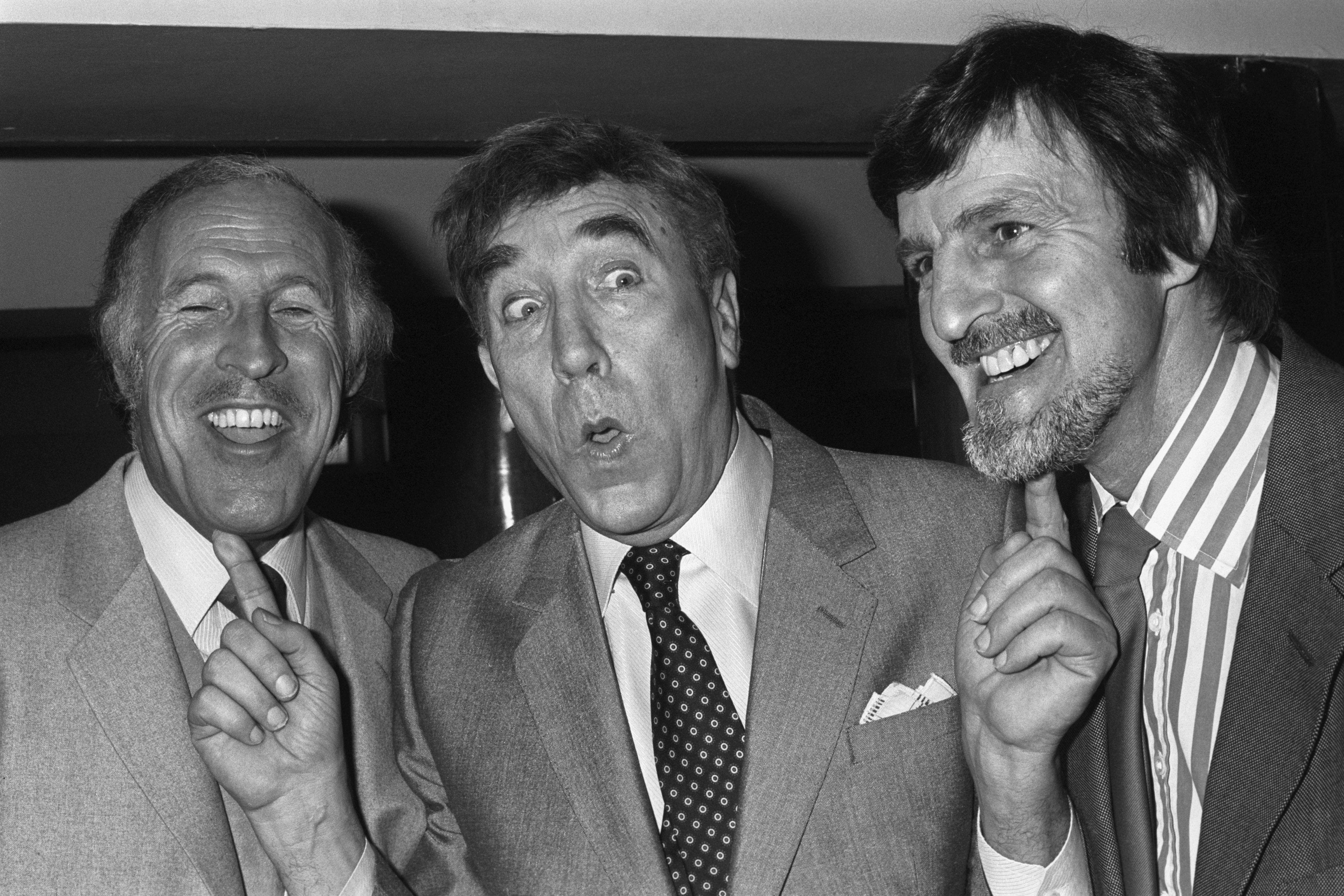 Frankie Howard puts his fingers on two of the most famous chins on television, Bruce Forsyth and Jimmy Hill (PA)
