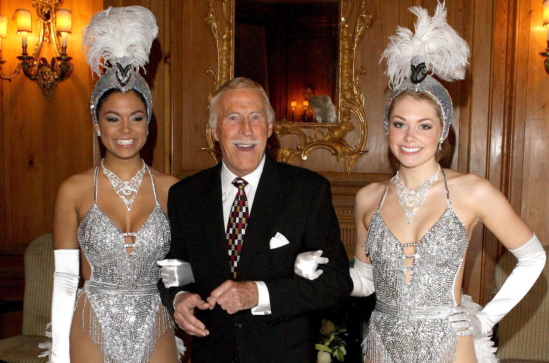 On his 80th birthday he was joined by Miss Puerto Rico (left) and Miss England dressed as showgirls (PA)