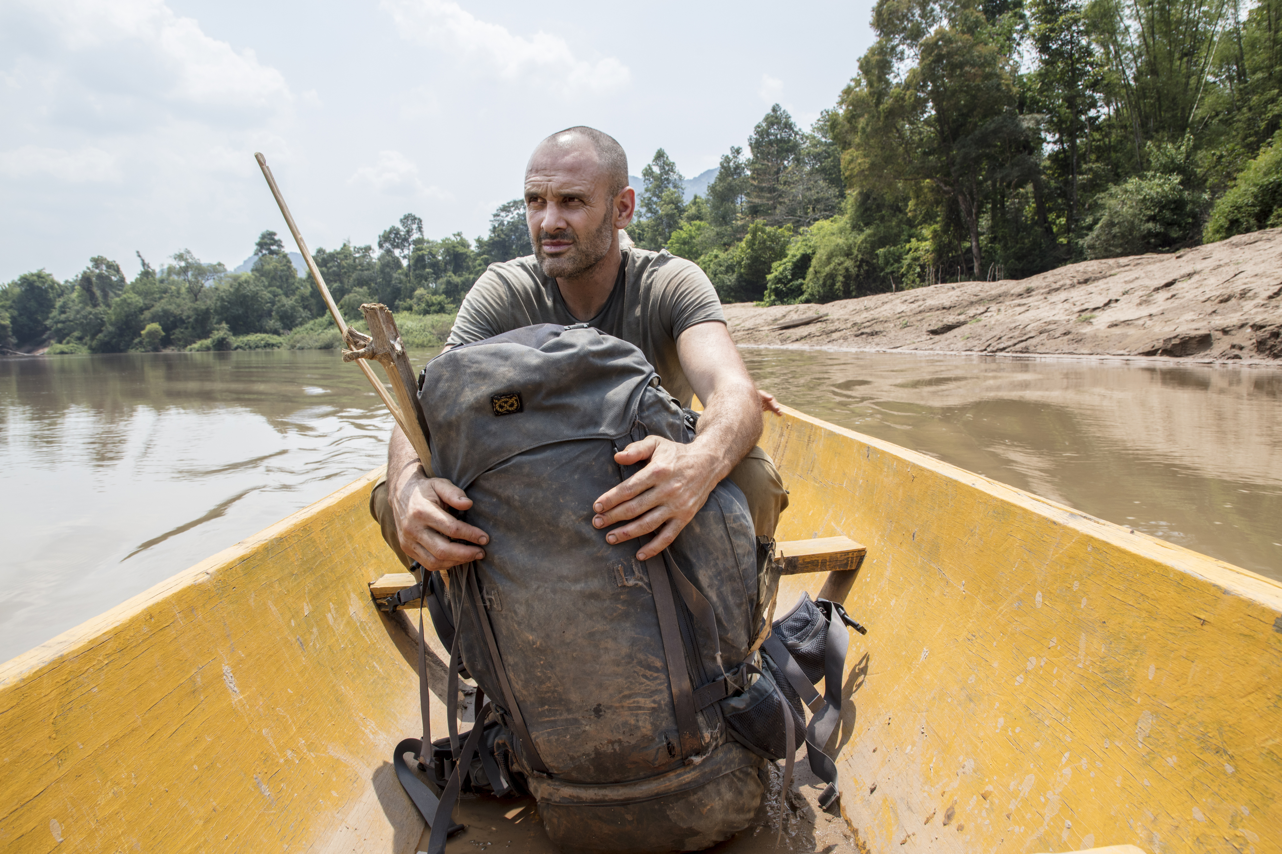 Ed Stafford on a canoe with a backpack