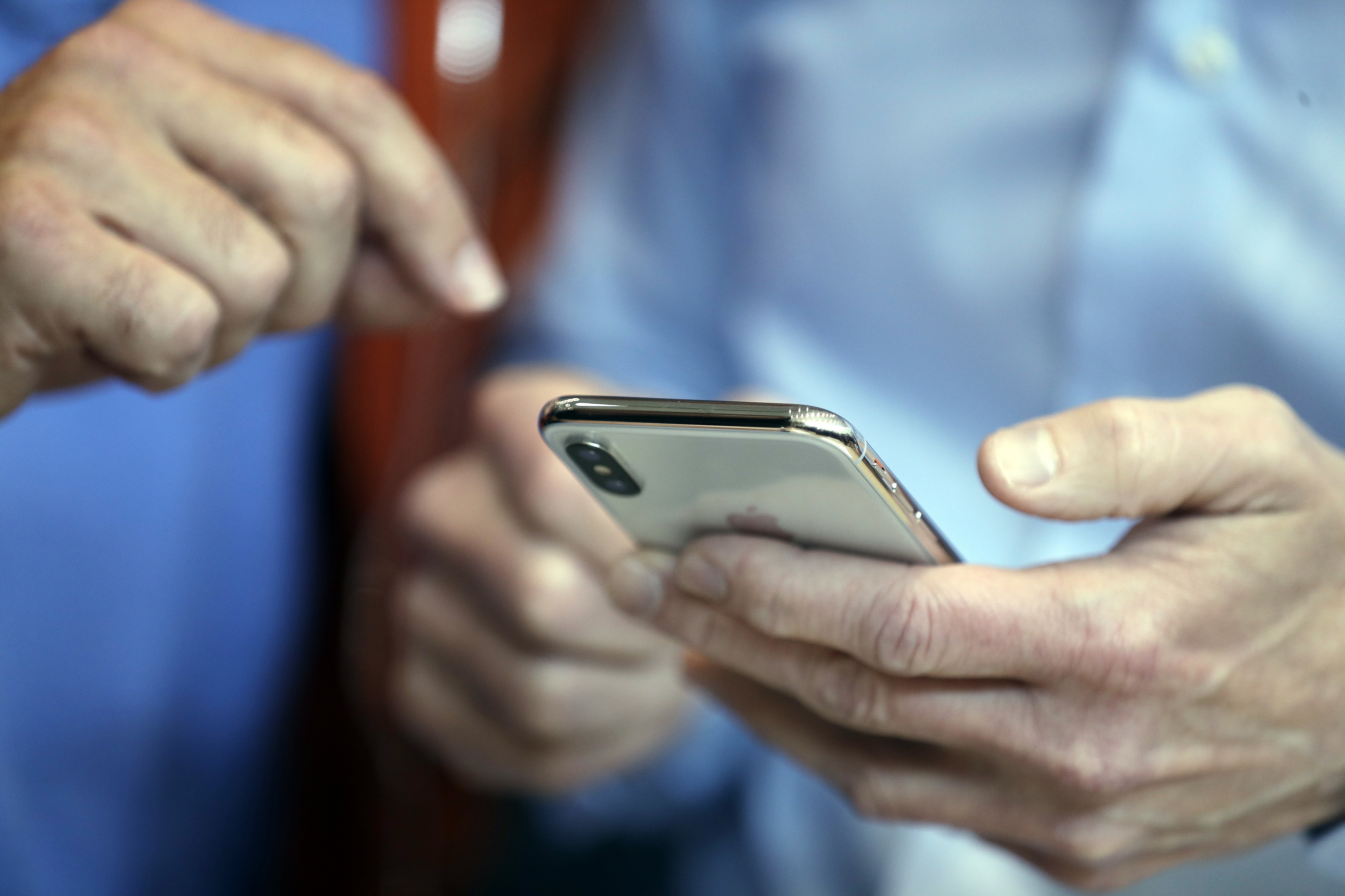 Tim Cook holds a new iPhone X