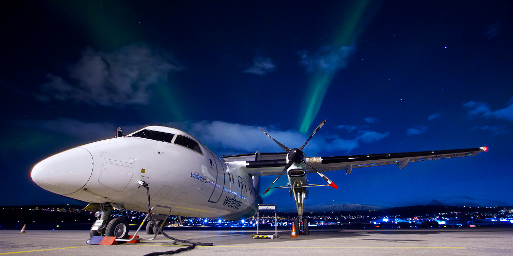 Plane with aurora in background