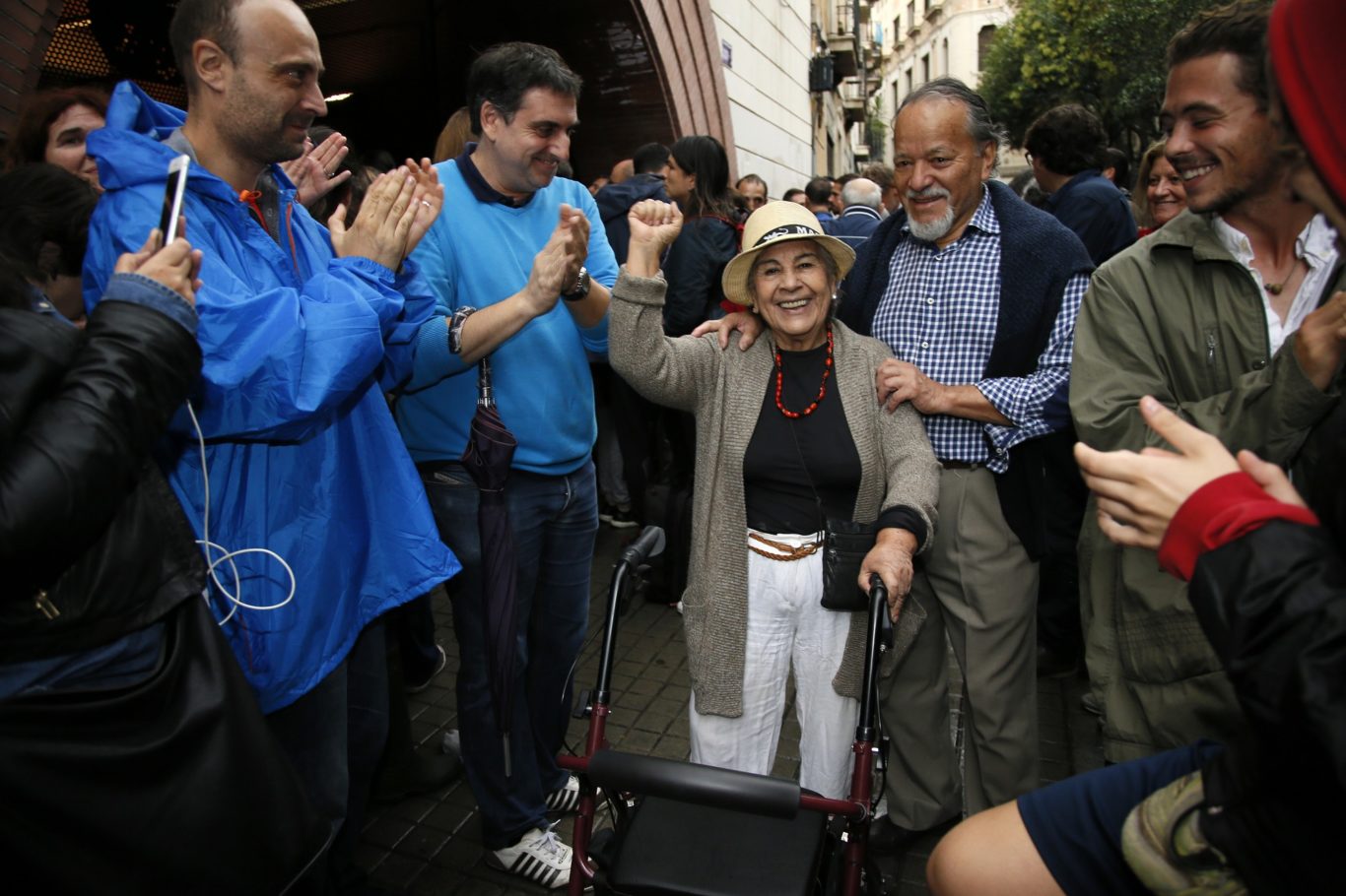 A woman raises her fist into the air (Bob Edme/AP)