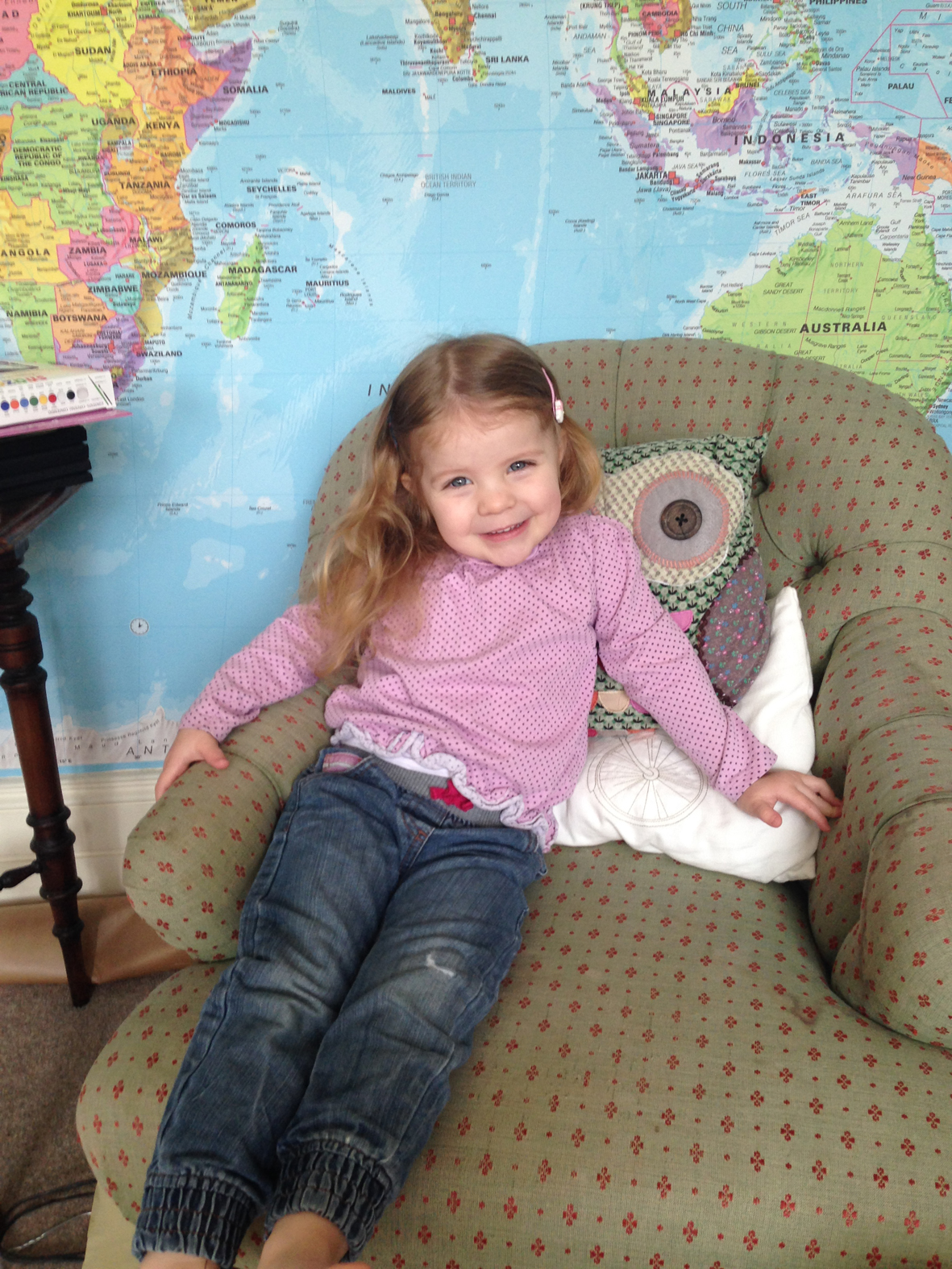 Image of Genevieve Burr, in front of a wallpapered feature wall