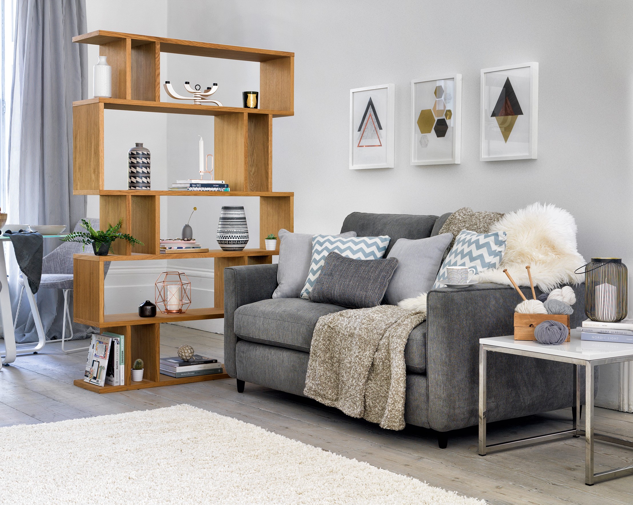 Esprit two seater fabric sofa, £549, currently reduced online to £499; Content by Conran Elmari tall shelving unit, £449, Furniture Village (Furniture Village/PA)