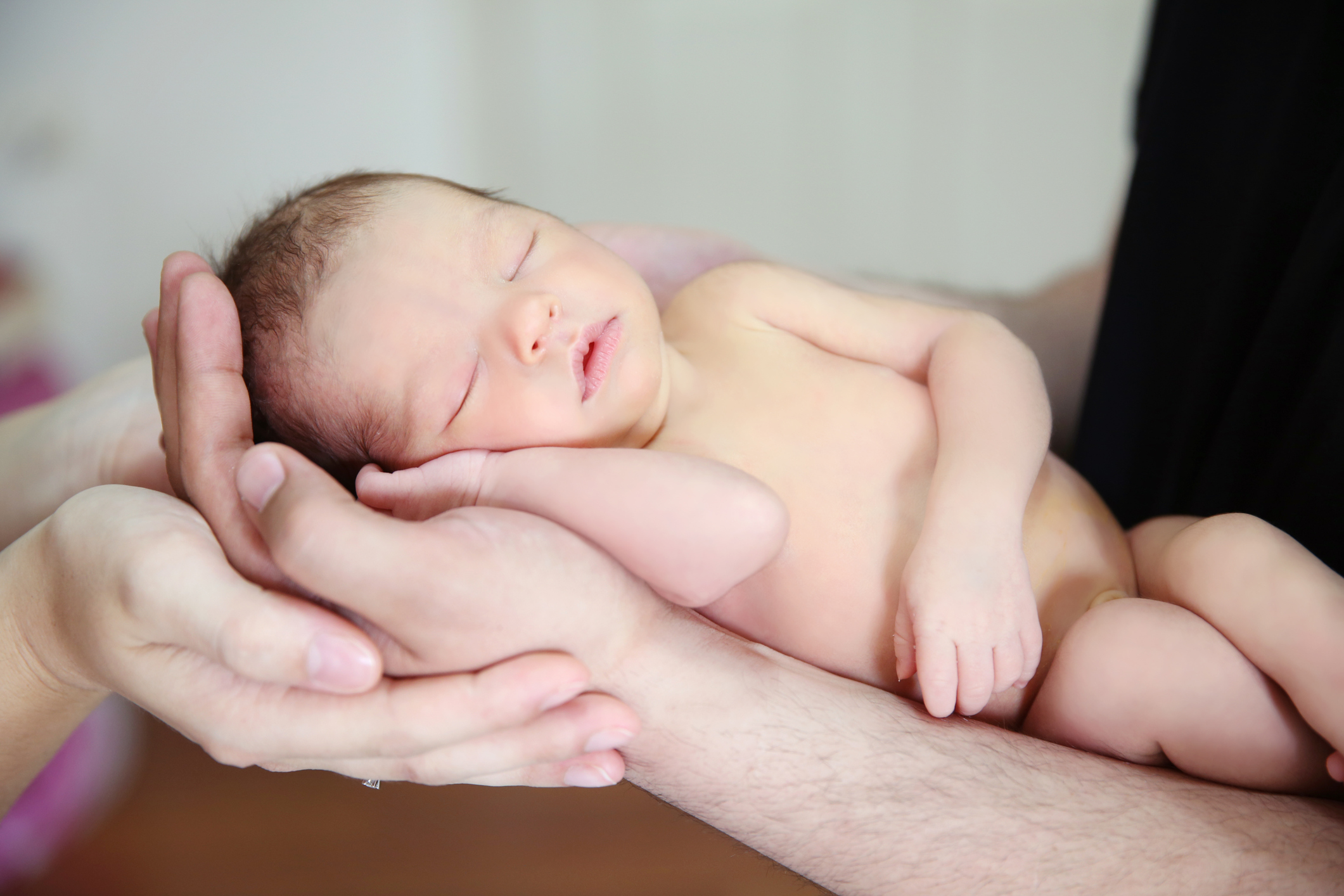 Hands of a new father and mother holding their newborn baby (Thinkstock/PA)
