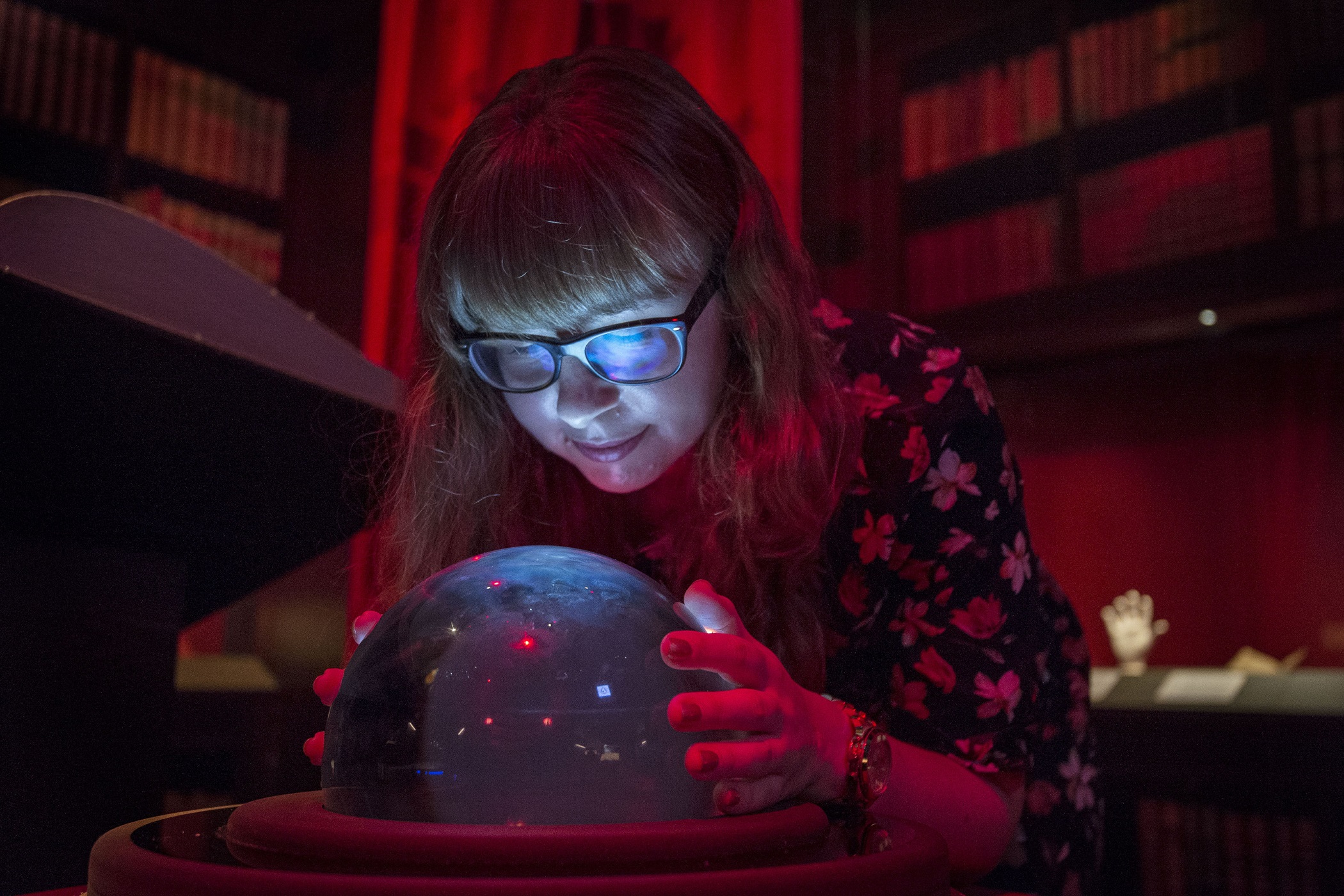 A visitor looks at a crystal ball at the British Library (Victoria Jones/PA)