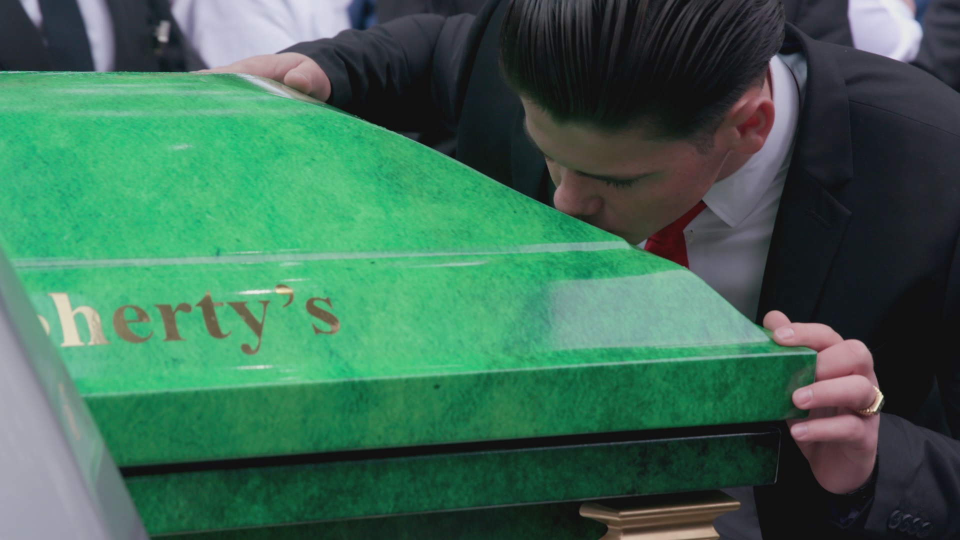 Tomboy kisses grandfather Simon Doherty's coffin.