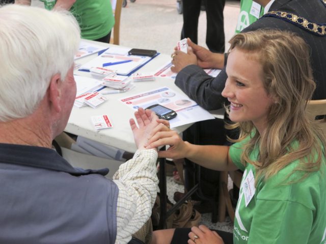 A woman checks a man's pulse (AF Association/PA)
