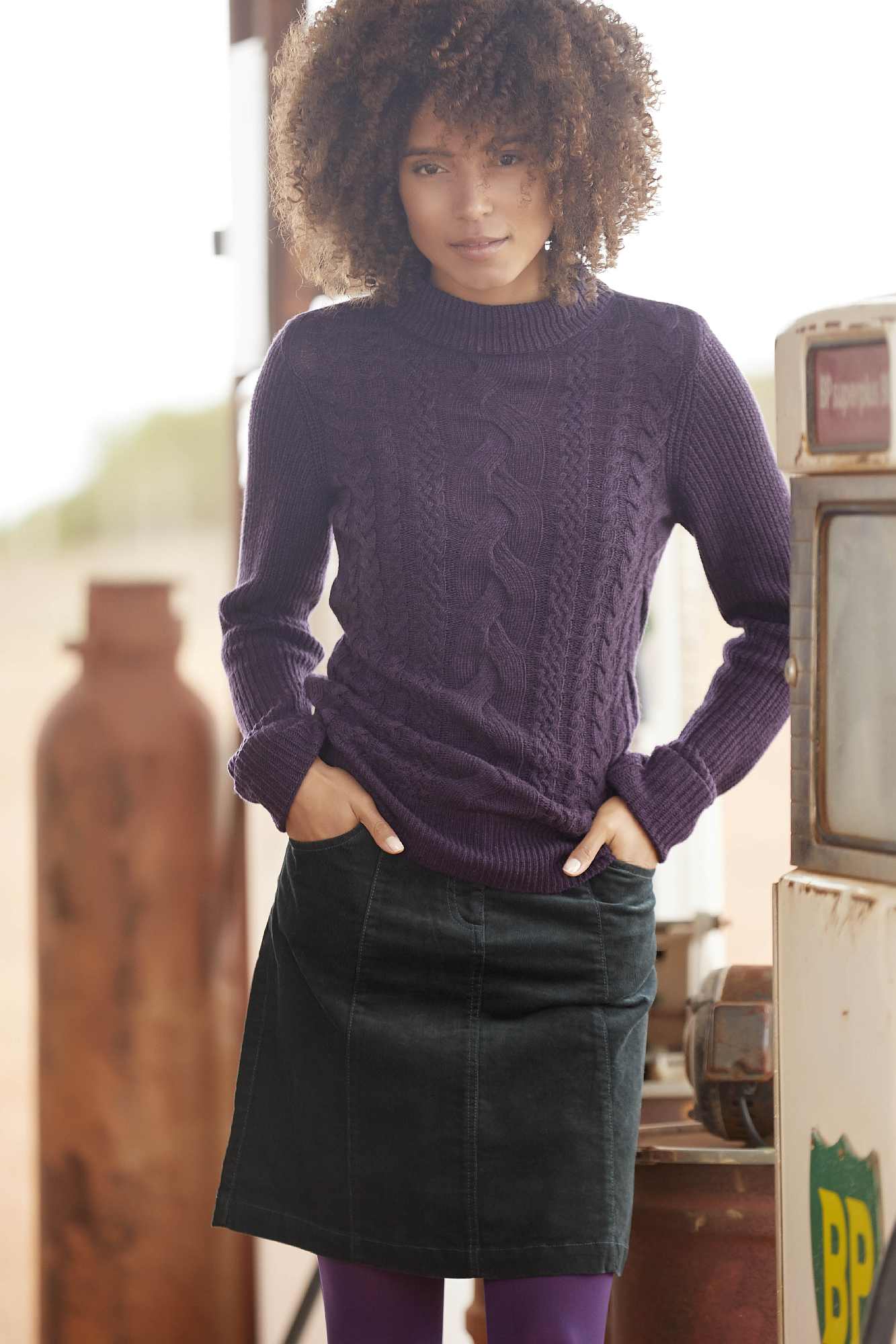 model wearing M&Co Petite Cable Knit Turtle Neck Jumper and Petite A-Line Cord Skirt