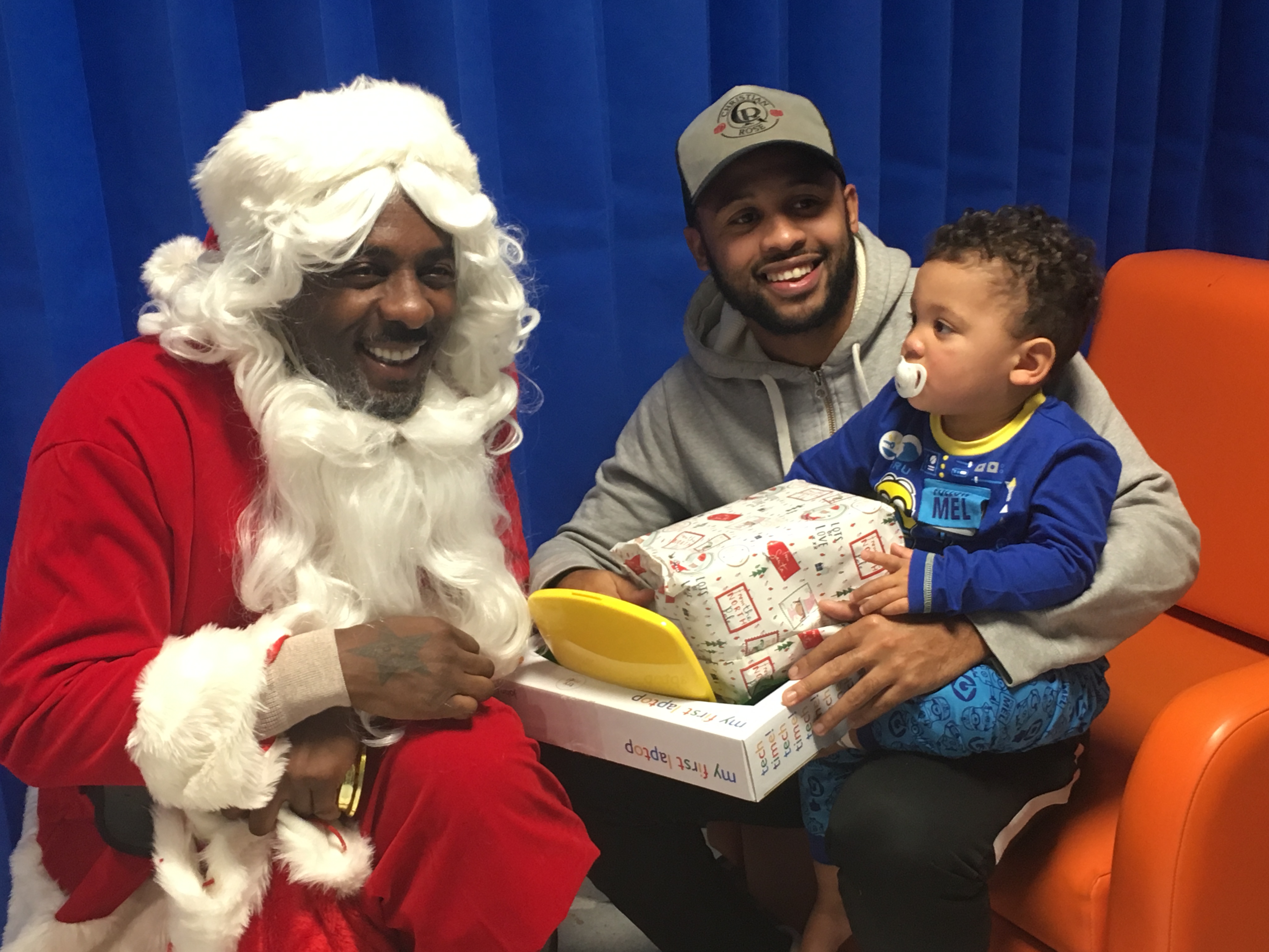 Idris Elba with a young patient and his father (Barts Health/PA)