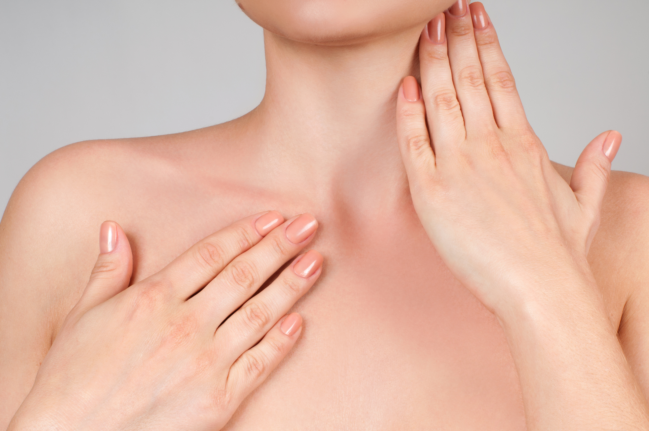 Beautiful woman touching her neck