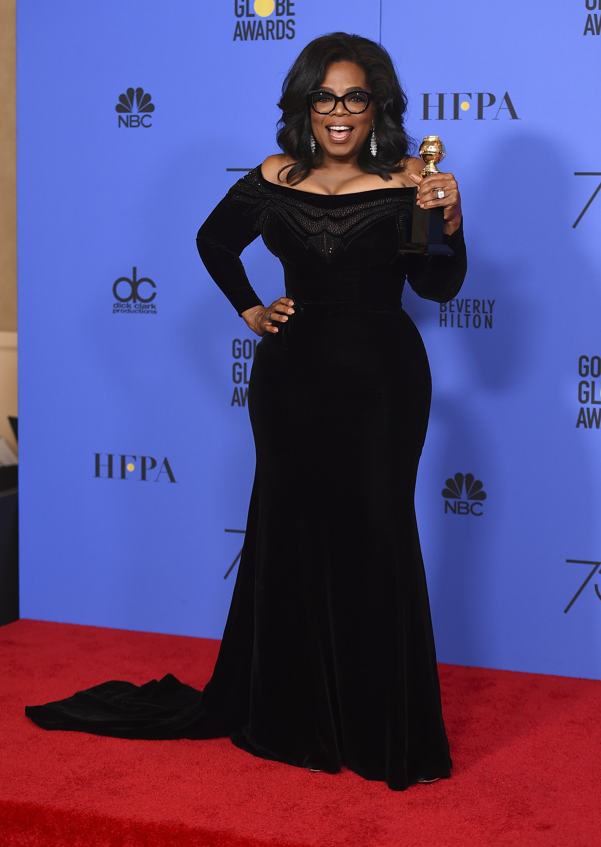 Oprah Winfrey poses in the press room with the Cecil B DeMille Award at the 75th annual Golden Globe Awards (Jordan Strauss/Invision/AP)