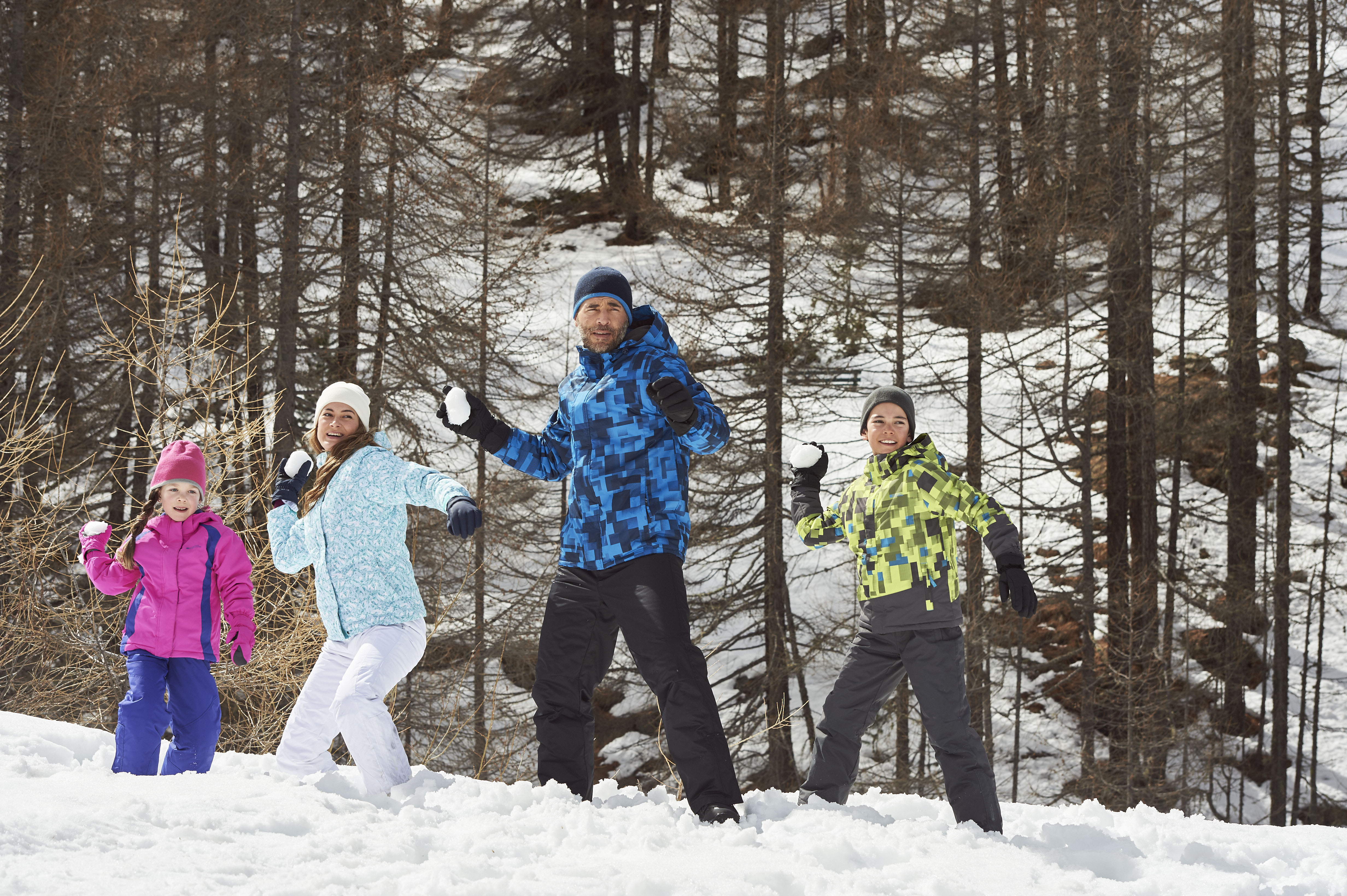 family of four wearing Mountain Warehouse Ski Outfit Packages