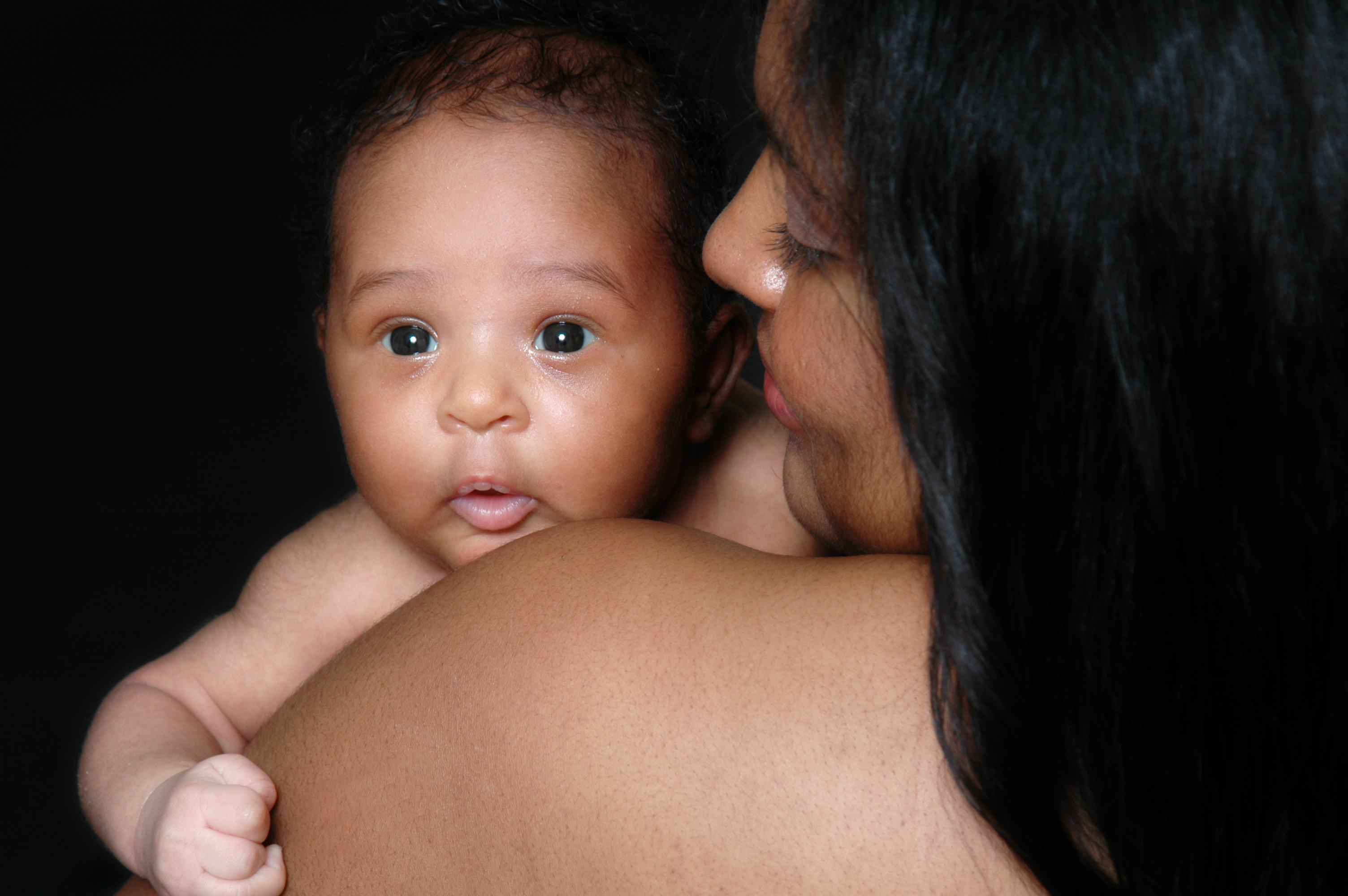 Baby girl being held by her mother over her shoulder. (Thinkstock/PA)