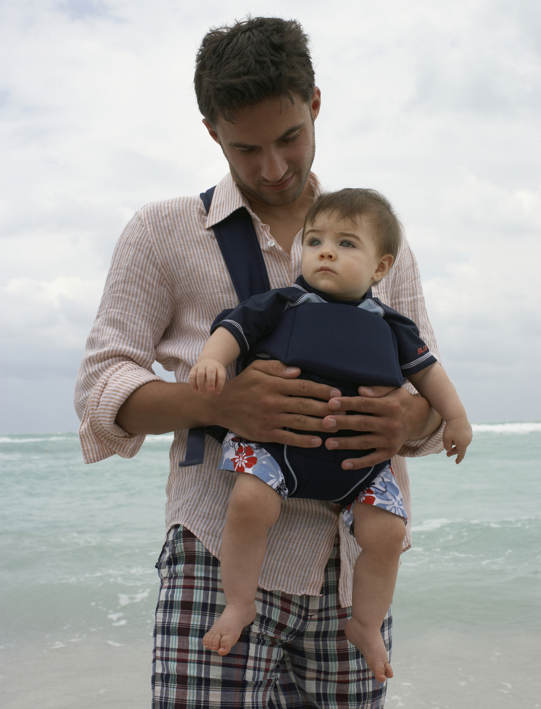 A man carrying his baby in a sling (Thinkstock/PA)
