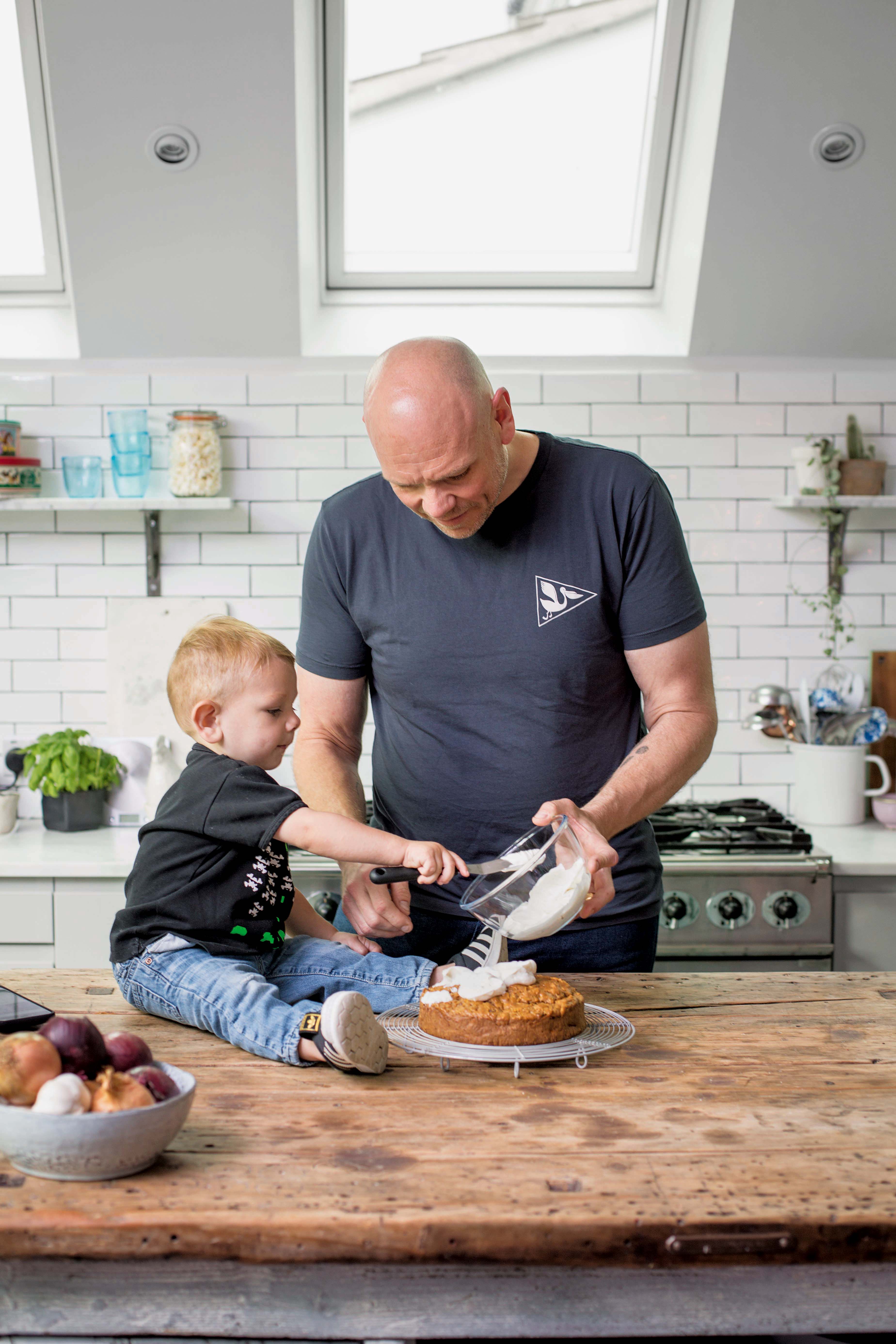 Tom and his two-year-old son making carrot cake with cream cheese frosting (© Cristian Barnett/PA)