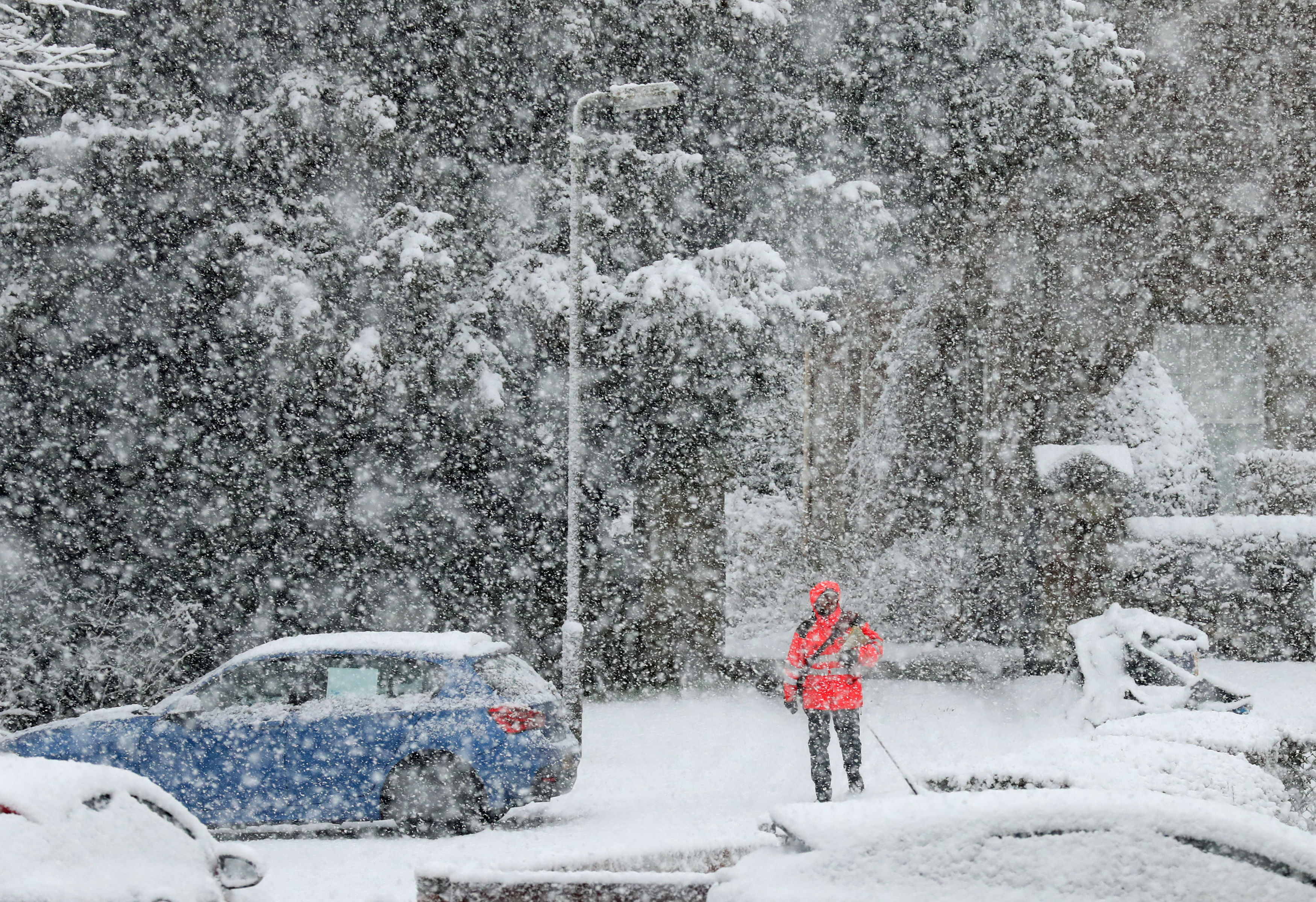 A postman delivers mail in snowy conditions in Braco, Perthshire (Andrew Milligan/PA)