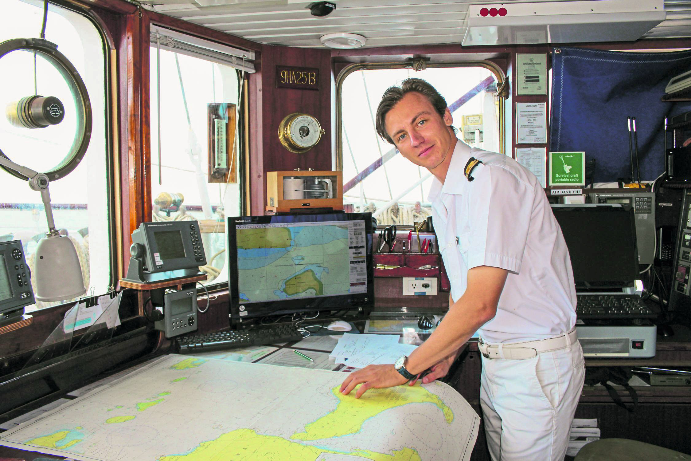Second Navigational Officer Vadim Novikov explains to a guest how to plot a route at sea using only the sun and the stars (Chris Wiltshire/PA)