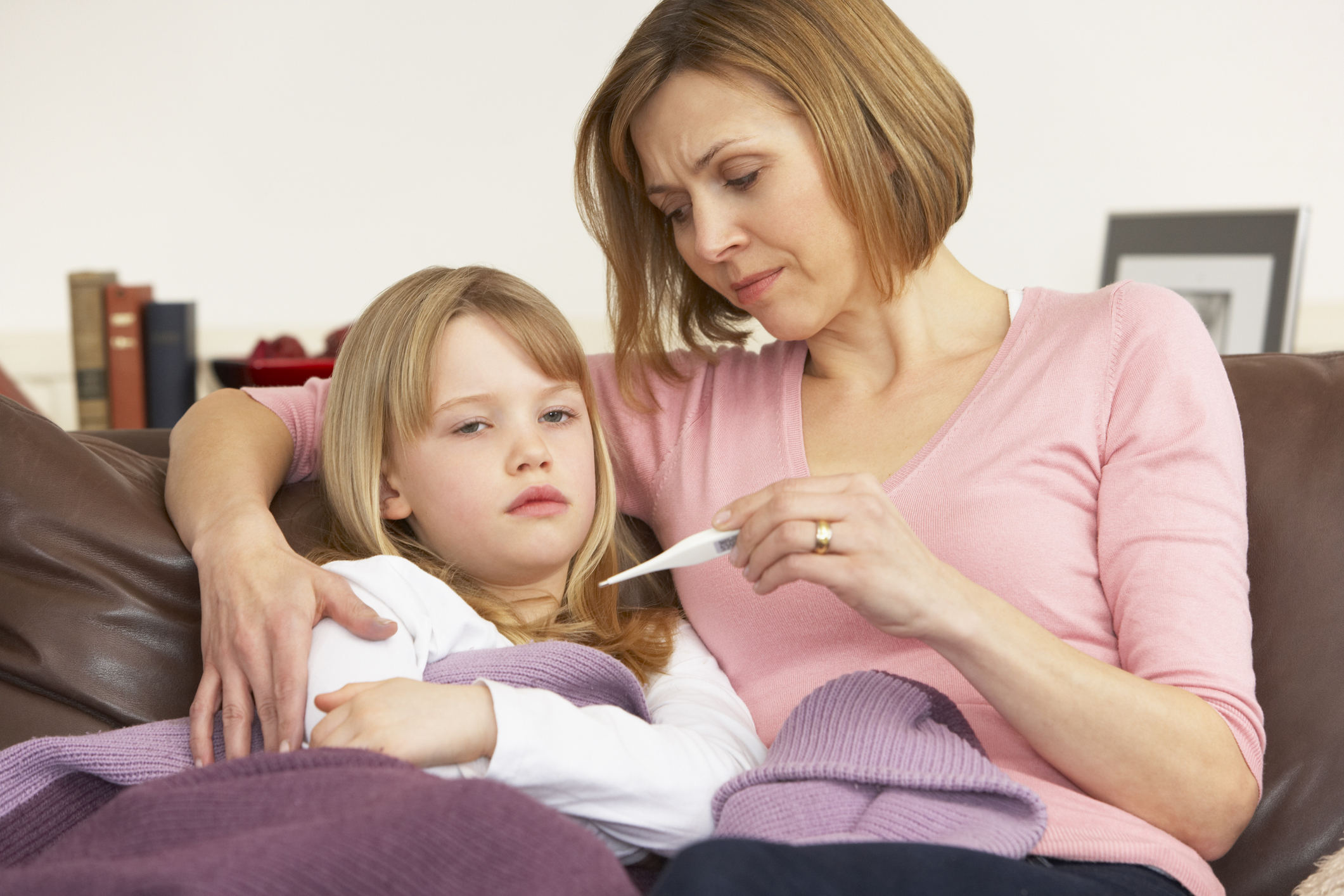 Mum comforts her sick child (Thinkstock/PA)