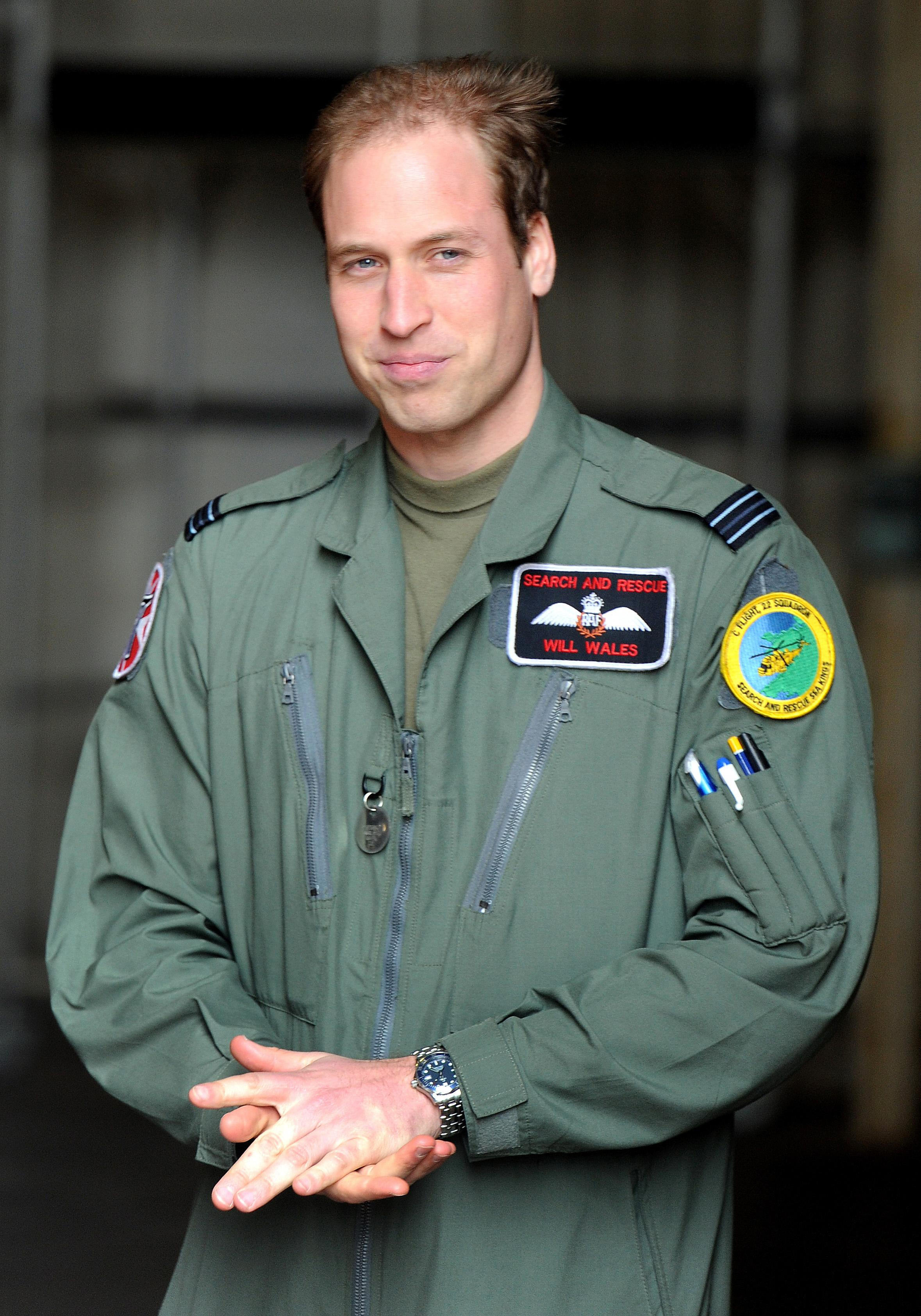 William standing in a helicopter hanger after saying goodbye to Britain's Queen Elizabeth II and the Duke of Edinburgh during a visit to RAF Valley in Anglesey in April 2011 (John Stillwell/PA)