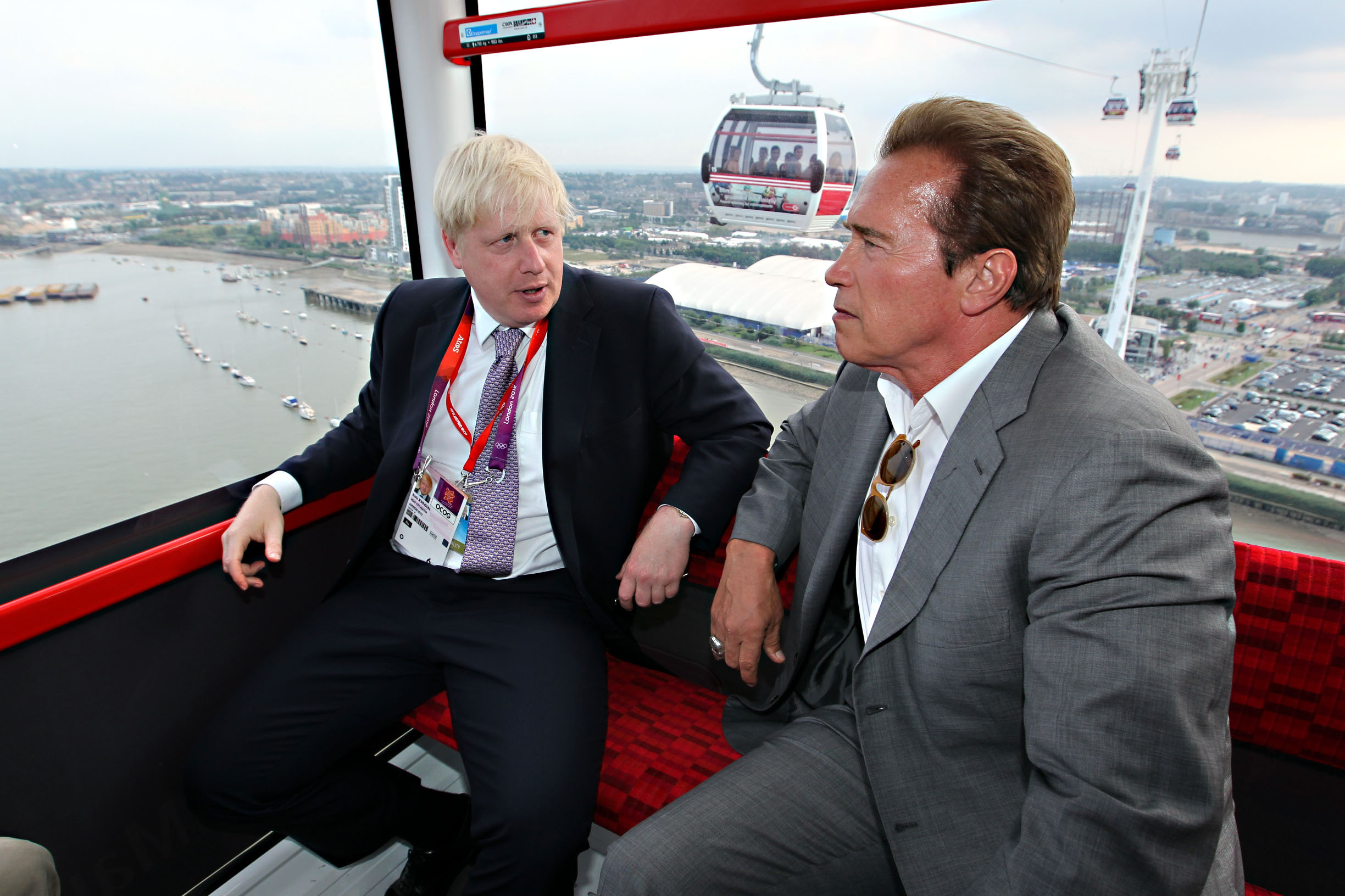 Mayor Boris Johnson (left) and Arnold Schwarzenegger take a ride on the Emirates cable car from Greenwich to the ExCeL in Docklands, after watching the Olympic basketball in Greenwich