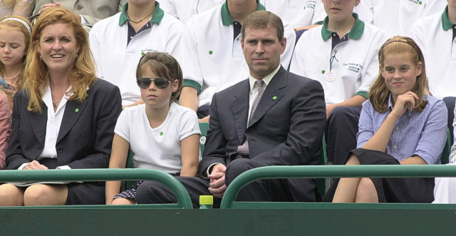 The Duke and Duchess of York sit with Beatrice (left) and Eugenie (right) in the grounds of Buckingham Palace at a charity tennis event in July 2000 (Fiona Hanson/PA)