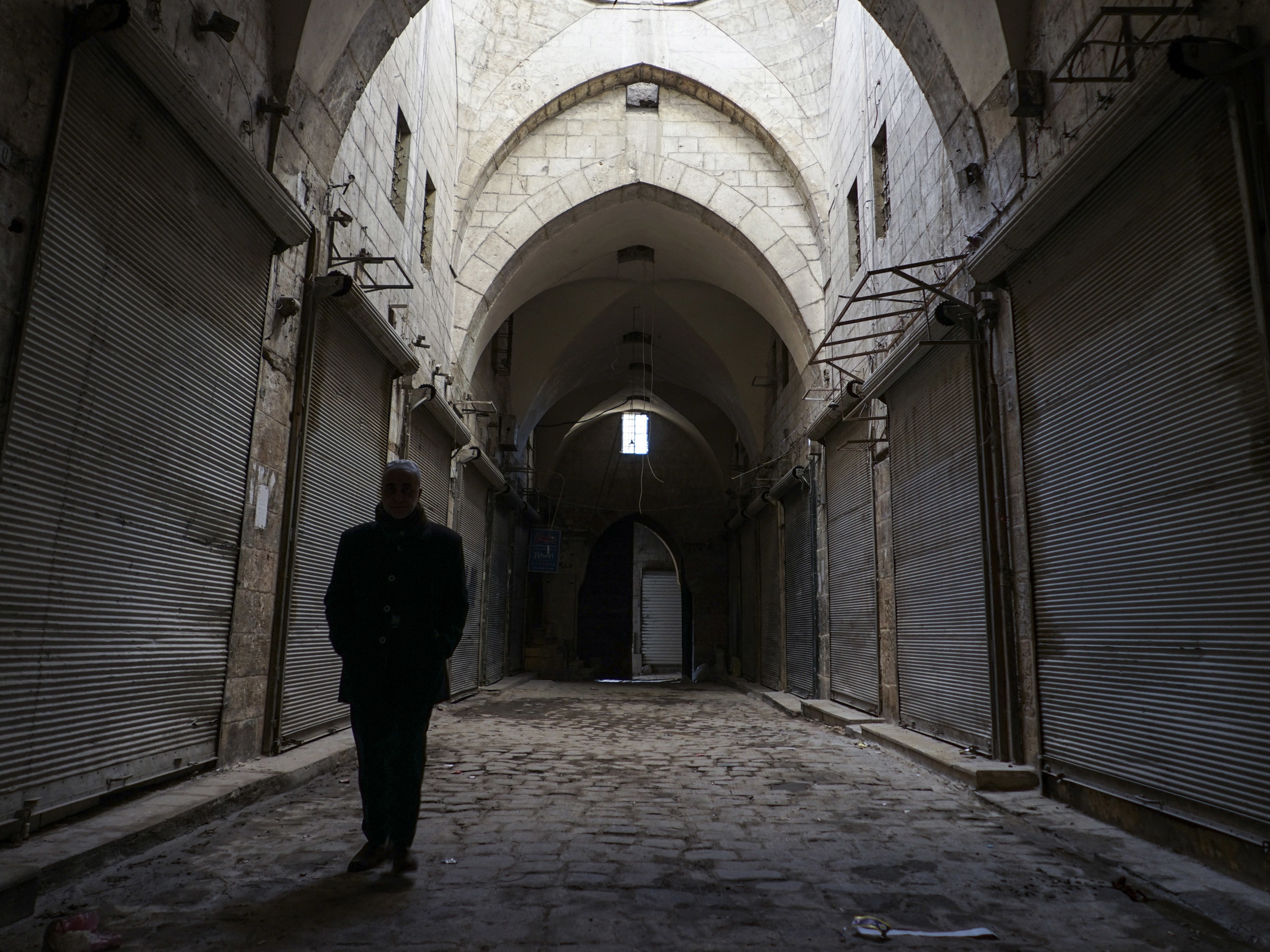 A man walks through the bazaar in Aleppo (Mstyslav Chernov/AP)