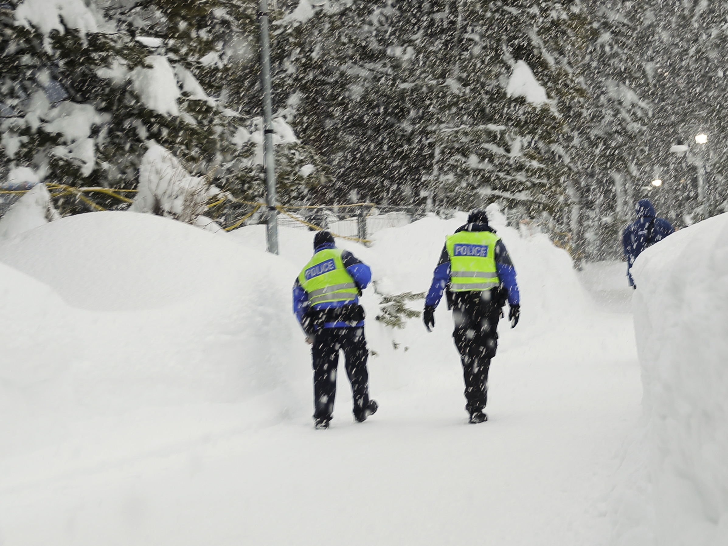 Police officers battling the elements in Davos (Markus Schreiber/AP)