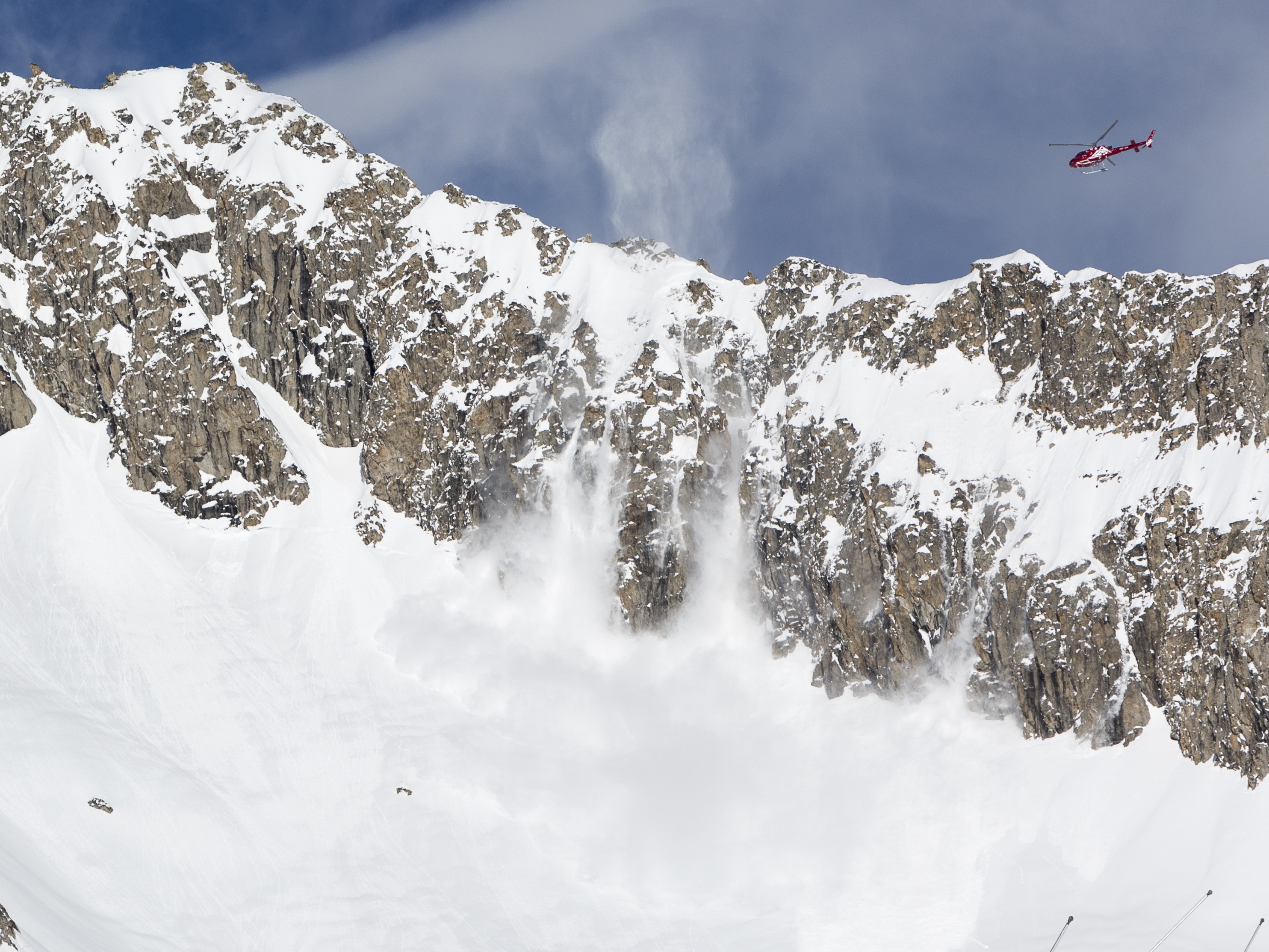 A helicopter tries to artificially cause an avalanche at the Belalp ski resort (Dominic Steinmann/AP)