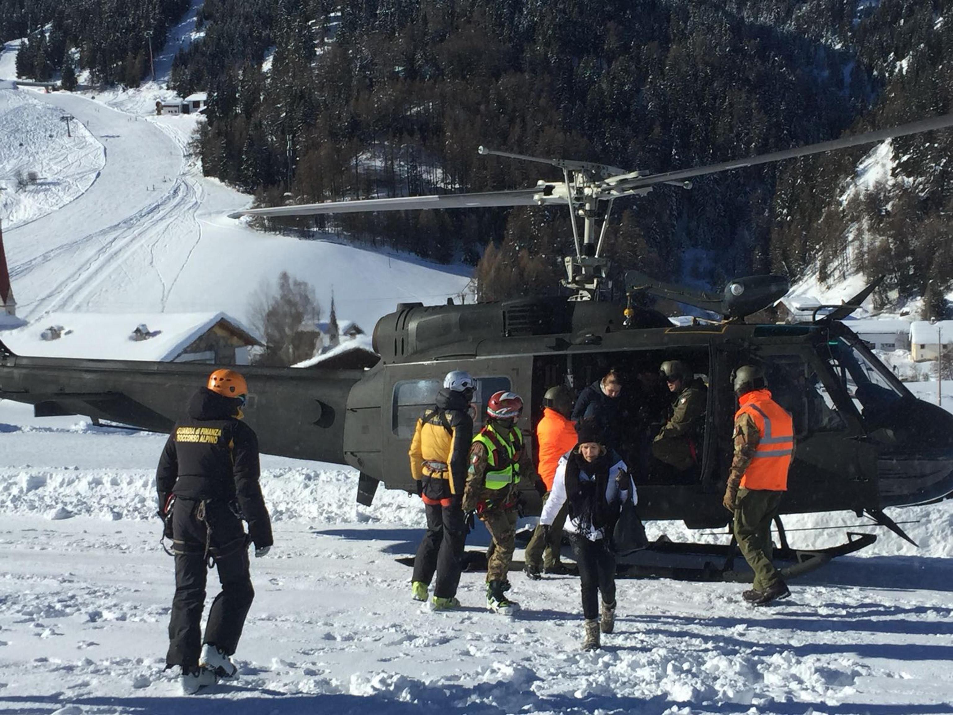 An Italian army helicopter lands during the evacuation of guests and tourists of the Langtauferer hotel in the Venosta valley, northern Italy (Italian Army via AP)