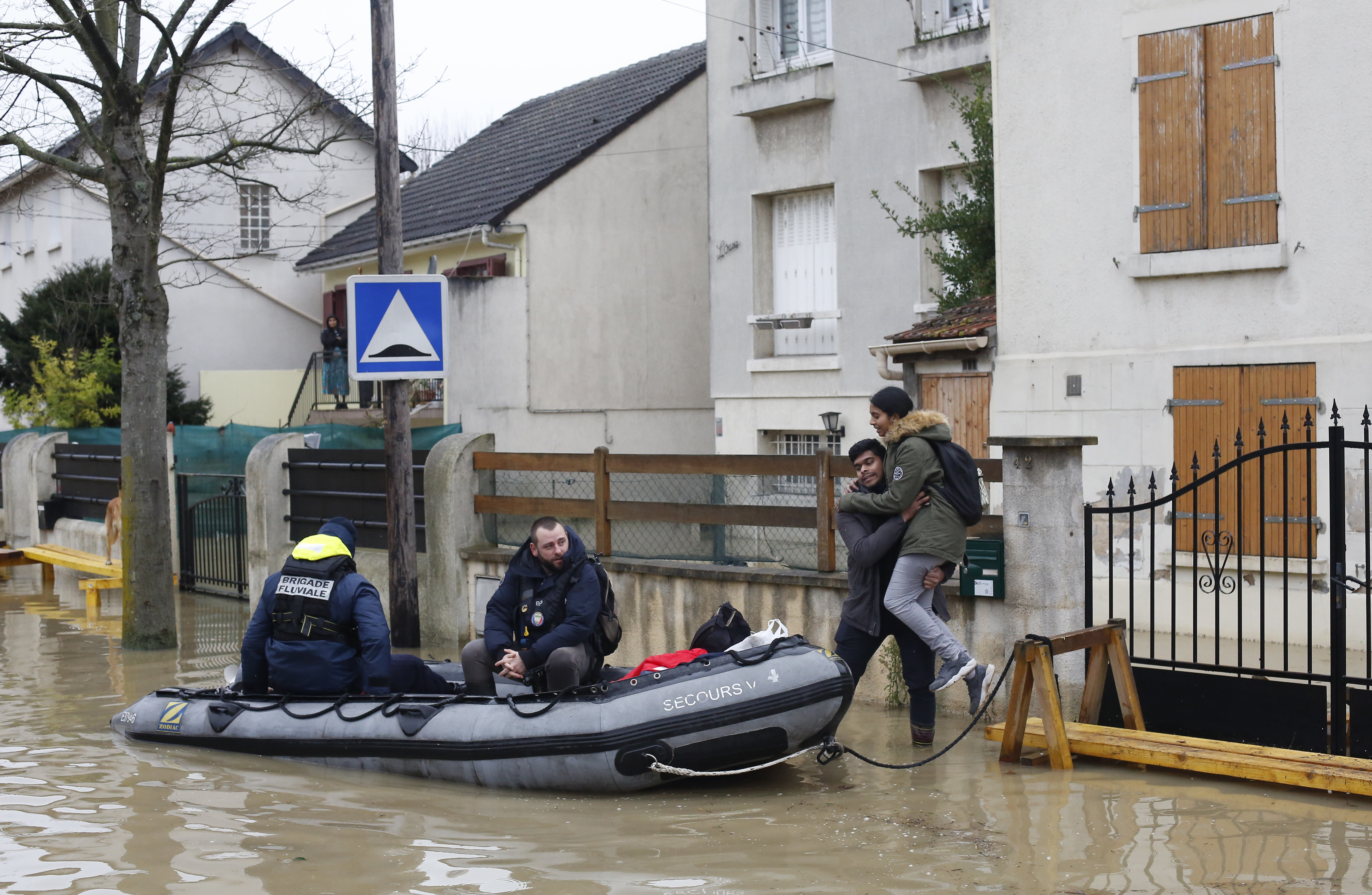Rescue workers evacuate residents in a flooded street of Villeneuve-Saint-Georges, outside Paris (Thibault Camus/AP)