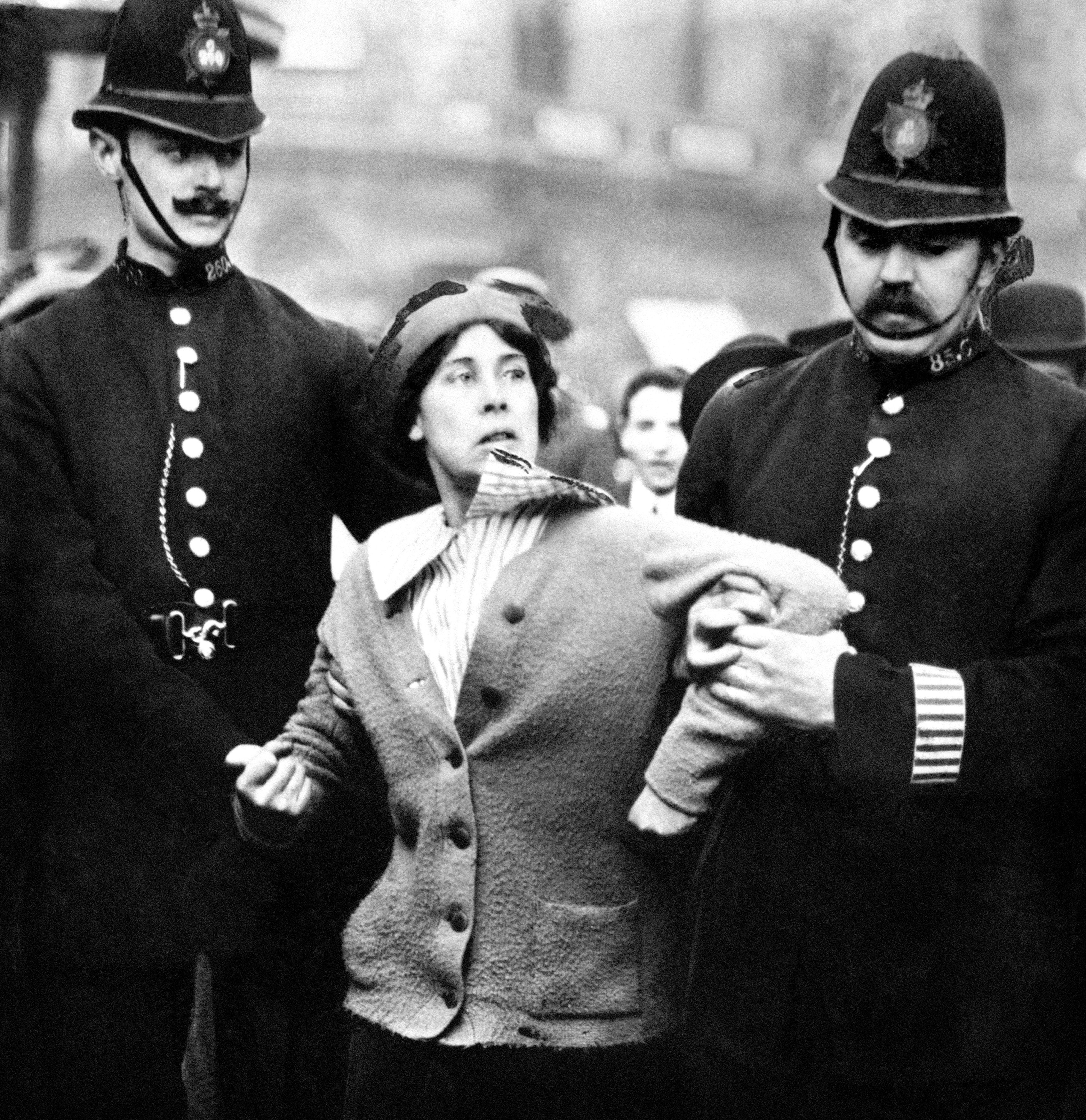 A suffragette being arrested by police officers in 1914 (PA)