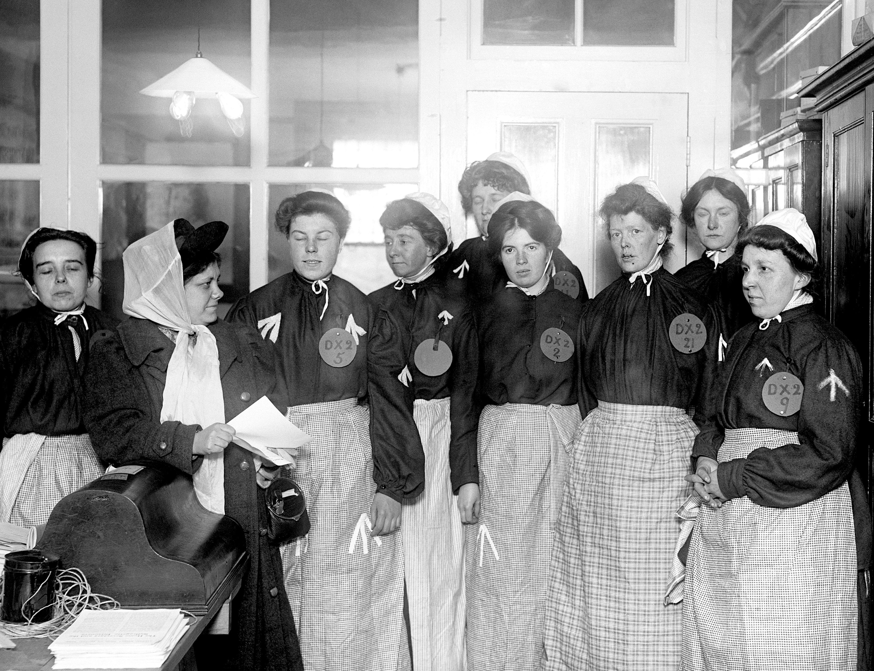Flora Drummond, left. giving instructions to suffragettes dressed as prisoners in 1908 (PA)