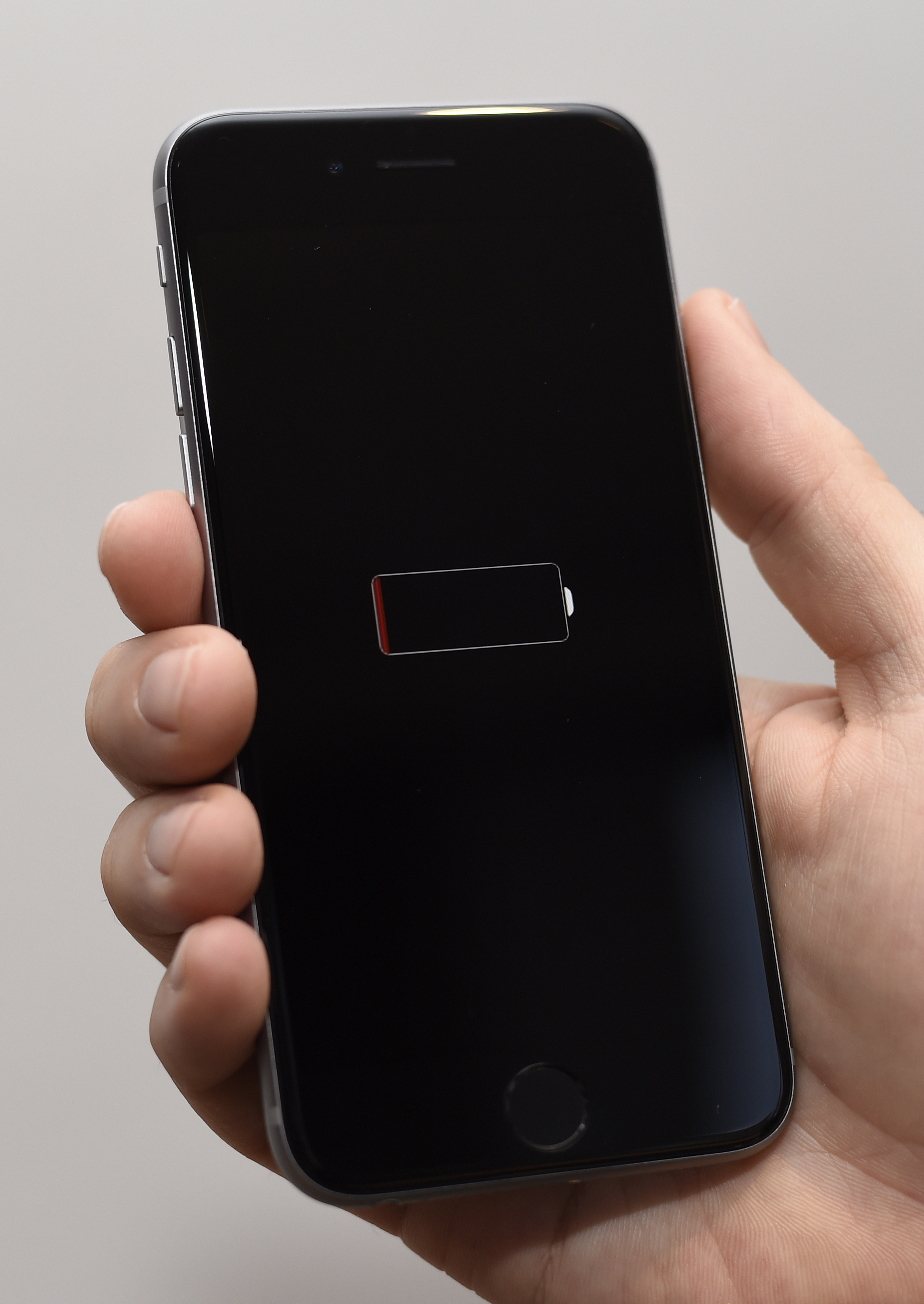 An iPhone with a black screen and a low battery icon