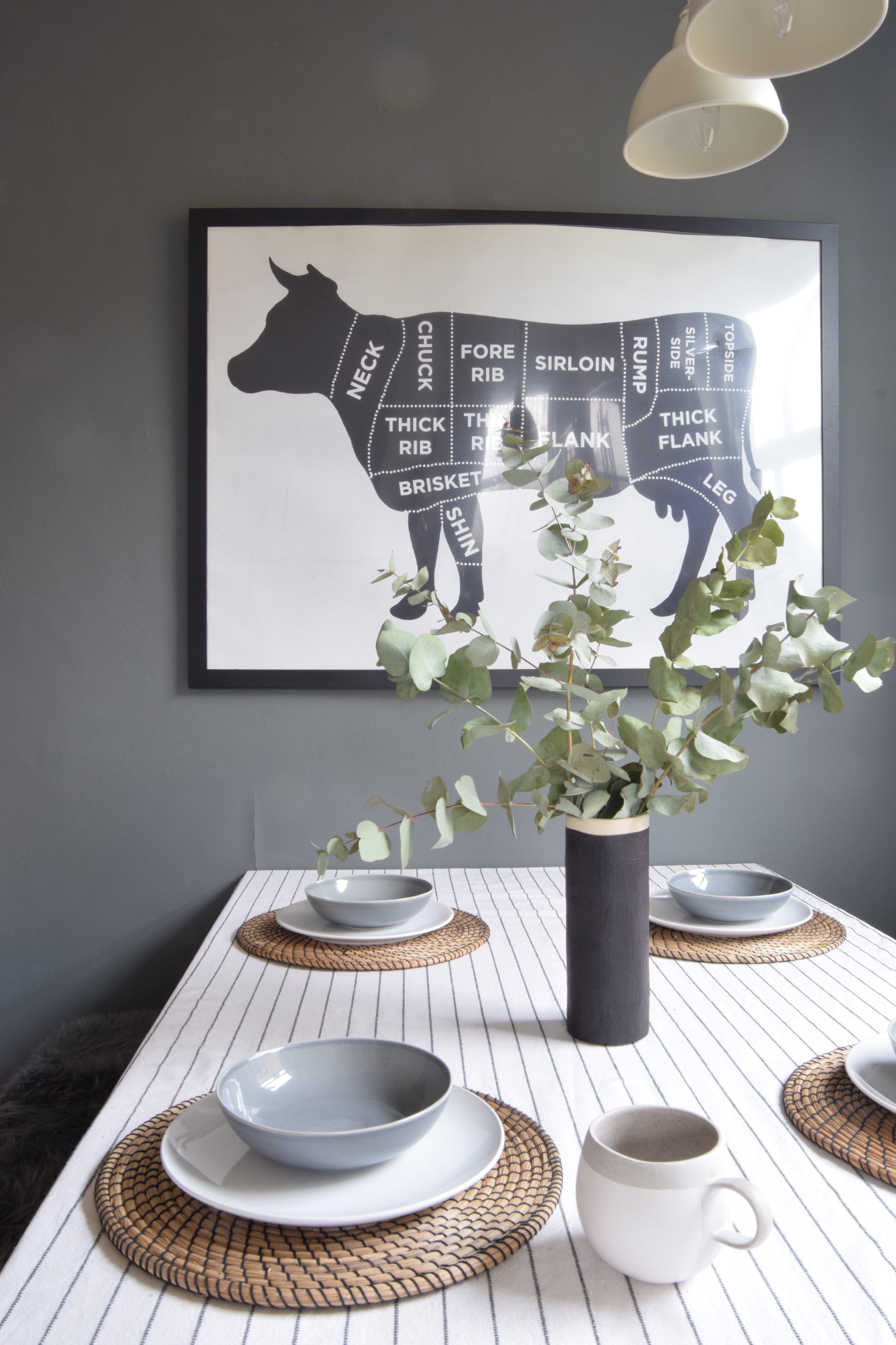 A dark grey feature wall makes a perfect contrast with a white tablecloth and china (Topology/PA)