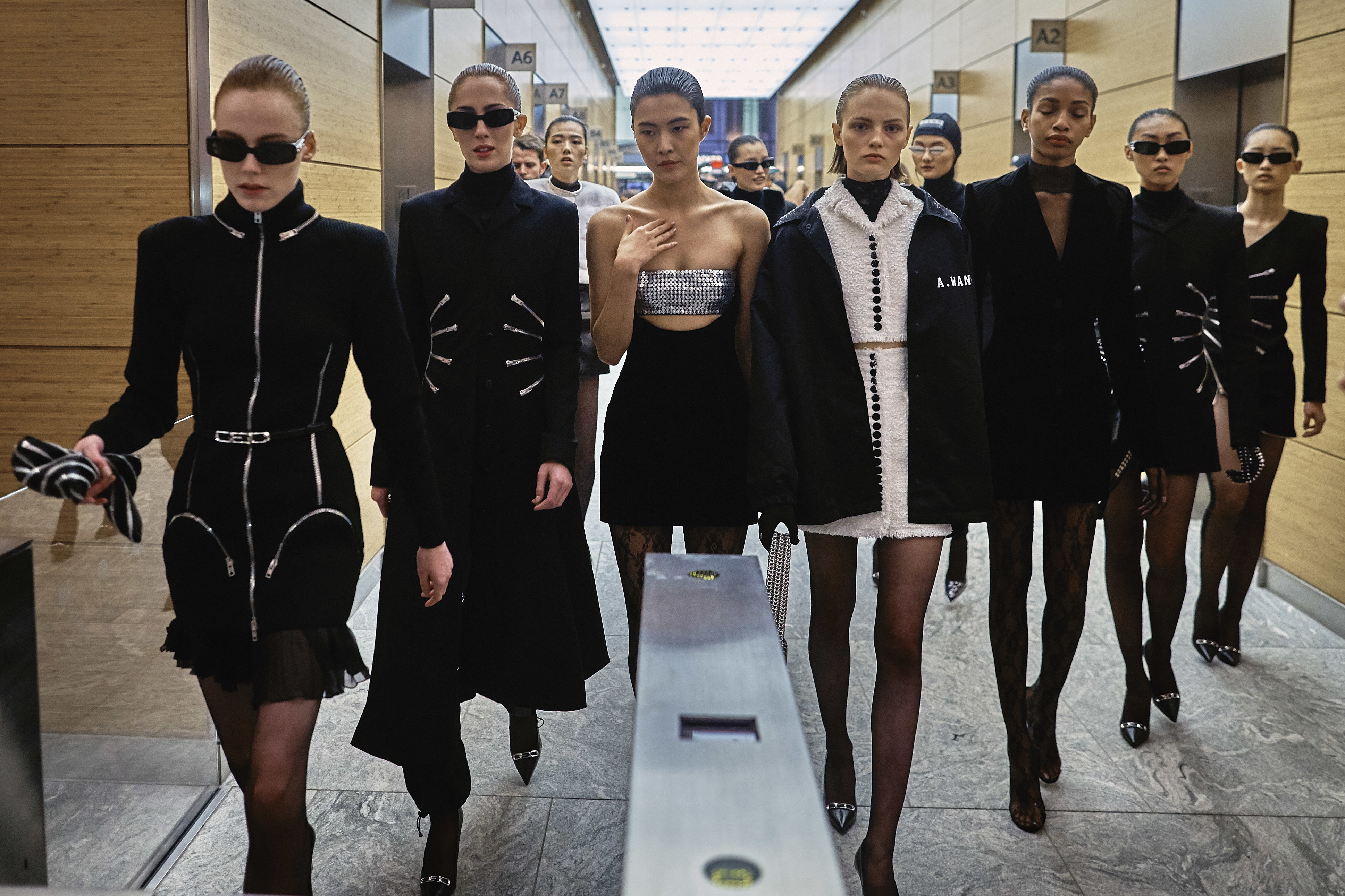 Models wearing the Alexander Wang collection walk to the street as part of the show during Fashion Week in New York (Andres Kudacki/AP)