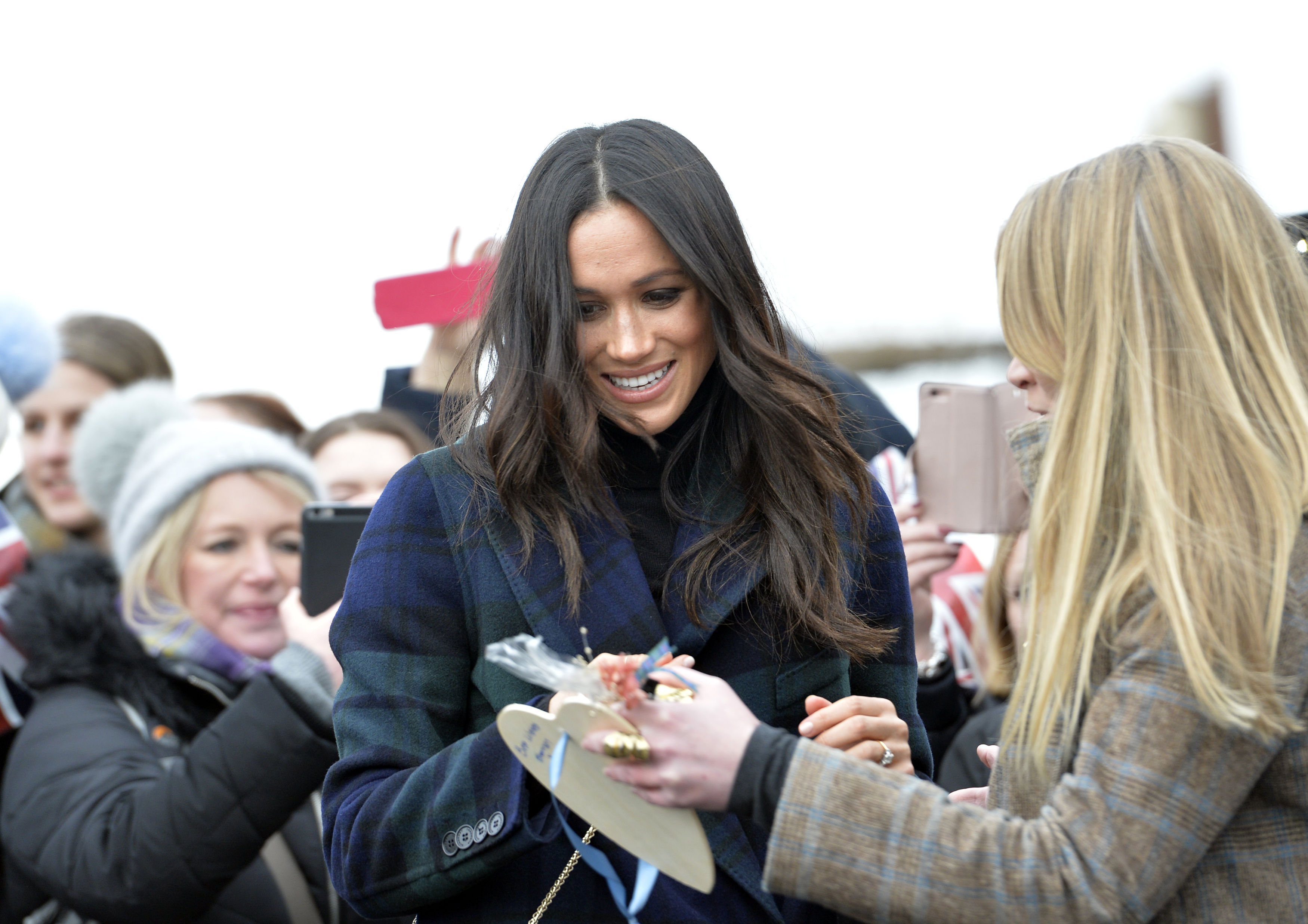Onlookers presented gifts to Meghan Markle during her walkabout (John Linton/PA)