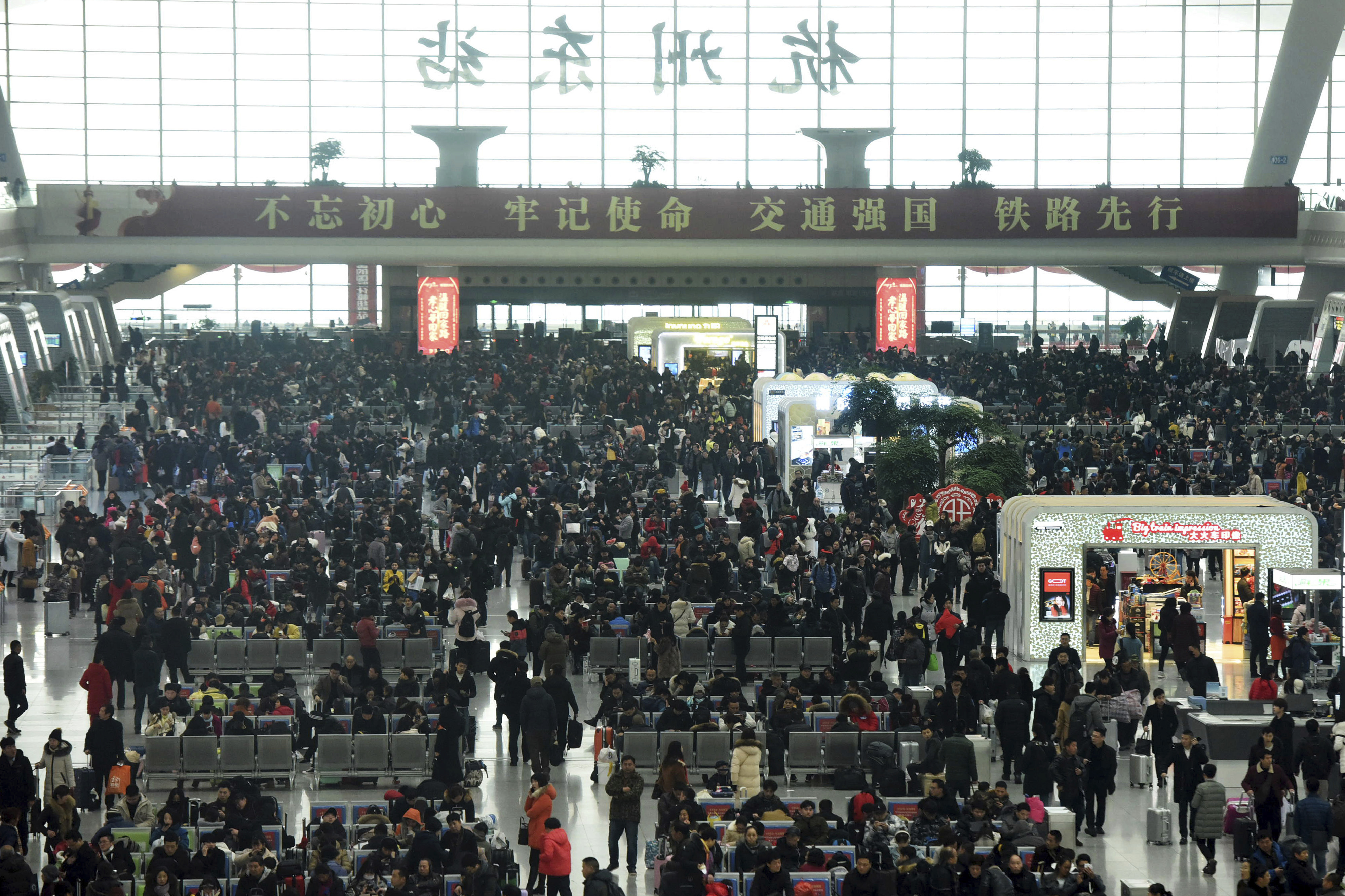 Passengers wait for their trains at the Hangzhou East Railway (Chinatopix/AP)