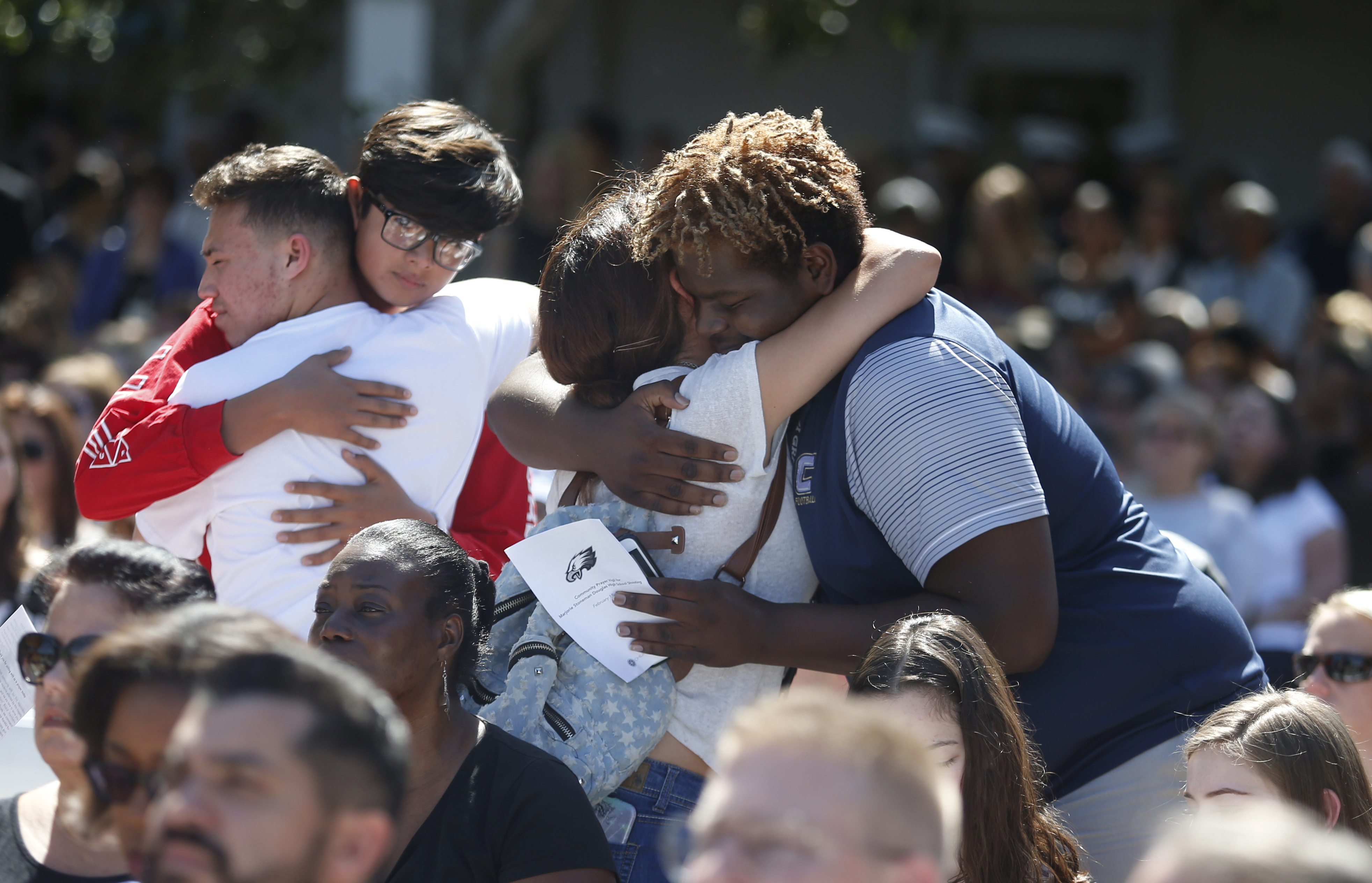 People comfort each other at a prayer vigil for the victims of the shooting (Wilfredo Lee/AP)